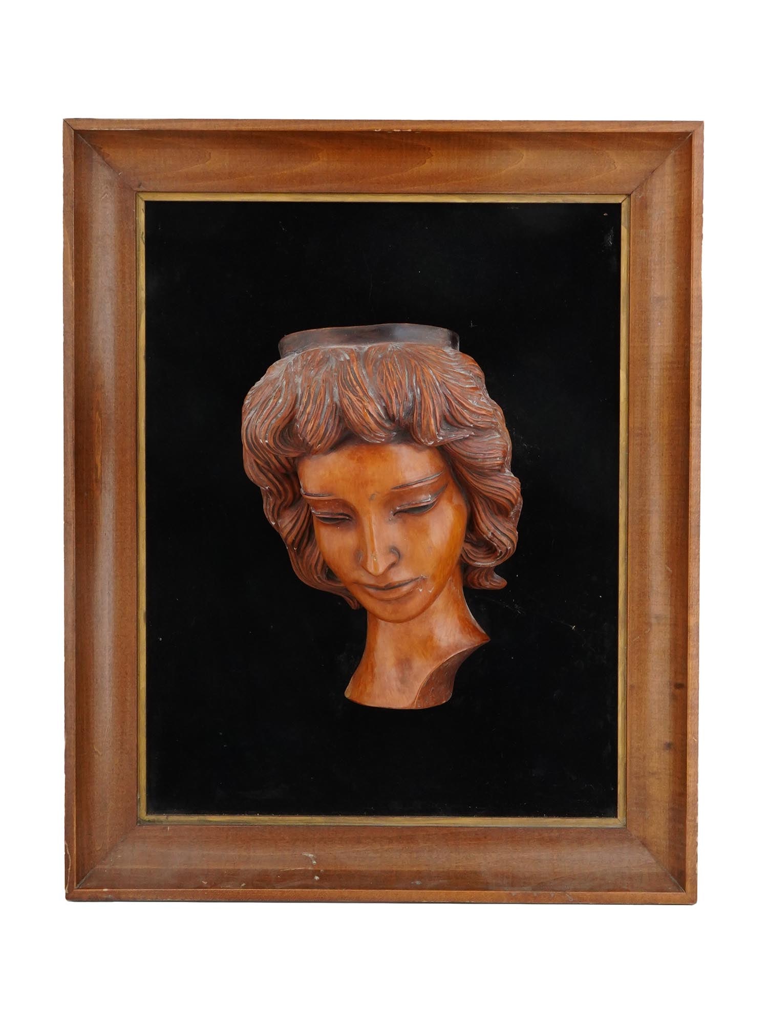 VINTAGE CARVED WOOD HEAD SCULPTURE IN FRAME: A vintage carved wood head sculpture in a frame. Circa mid to late 20th century. The artwork represents a well detailed female head against black background. Housed in a frame. Collectible Home Wall D