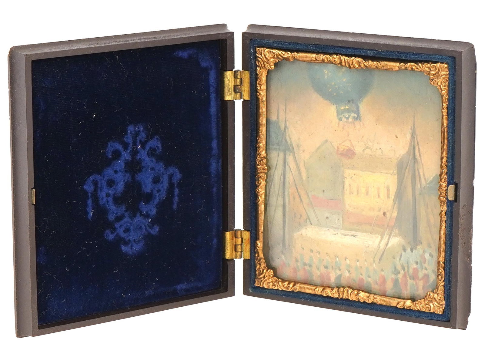 FRENCH AIR BALLOON MINIATURE PAINTING IN FOLDING CASE: A vintage French school air balloon miniature painting in a folding case. Circa the early to mid 20th century. The miniature painting features a genre scene with a hot air balloon taking off and a lar
