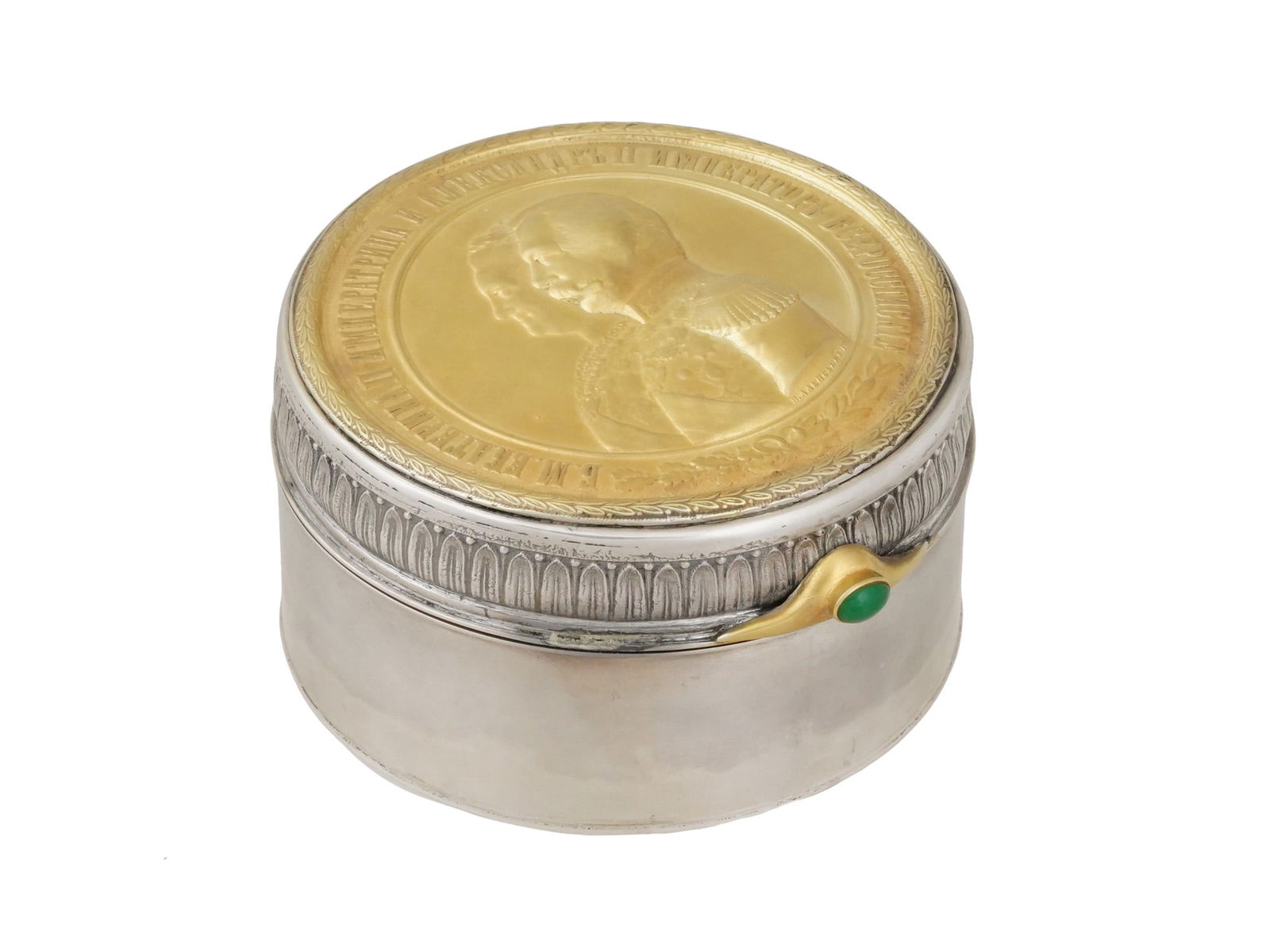 LARGE RUSSIAN SILVER PRESENTATION BOX W EMERALD: A Russian round silver Imperial Presentation pill box with hinged lid. The gilt lid is decorated with a relief profile portrait of Empress Catherine the Great and her great-grandson Emperor Alexander