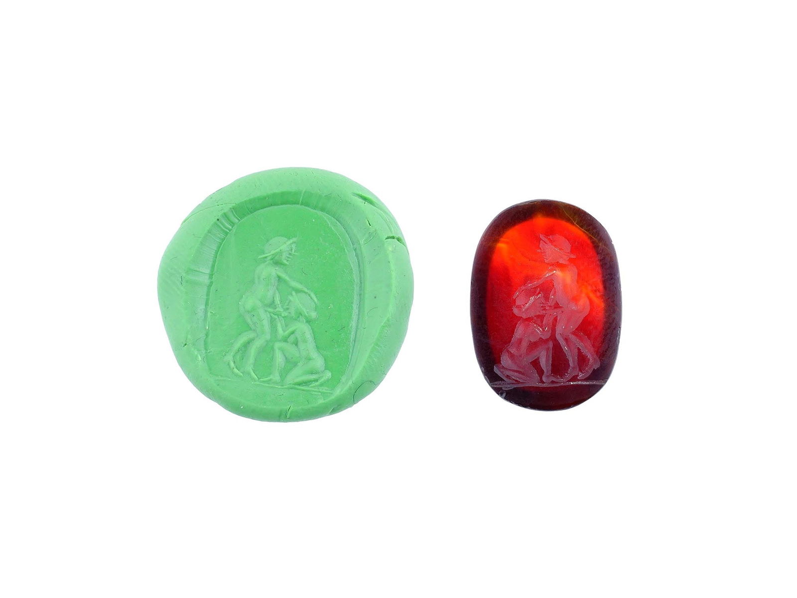 CARVED STONE INTAGLIO ANCIENT ROMAN EROTIC SCENE: A carved carnelian stone intaglio featuring an ancient Roman erotic scene involving two human figures. This detailed engraving reflects the artistic and symbolic traditions of antiquity, where such im