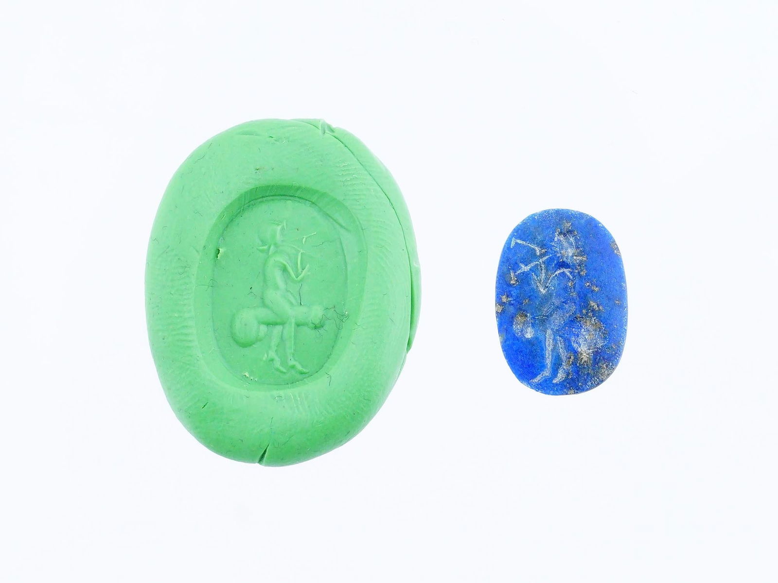 CARVED STONE INTAGLIO ANCIENT ROMAN EROTIC SCENE: A carved lapis lazuli stone intaglio featuring a depiction of an ancient Roman erotic scene involving a human figure sitting on an erected penis. This intricately detailed engraving reflects the artis
