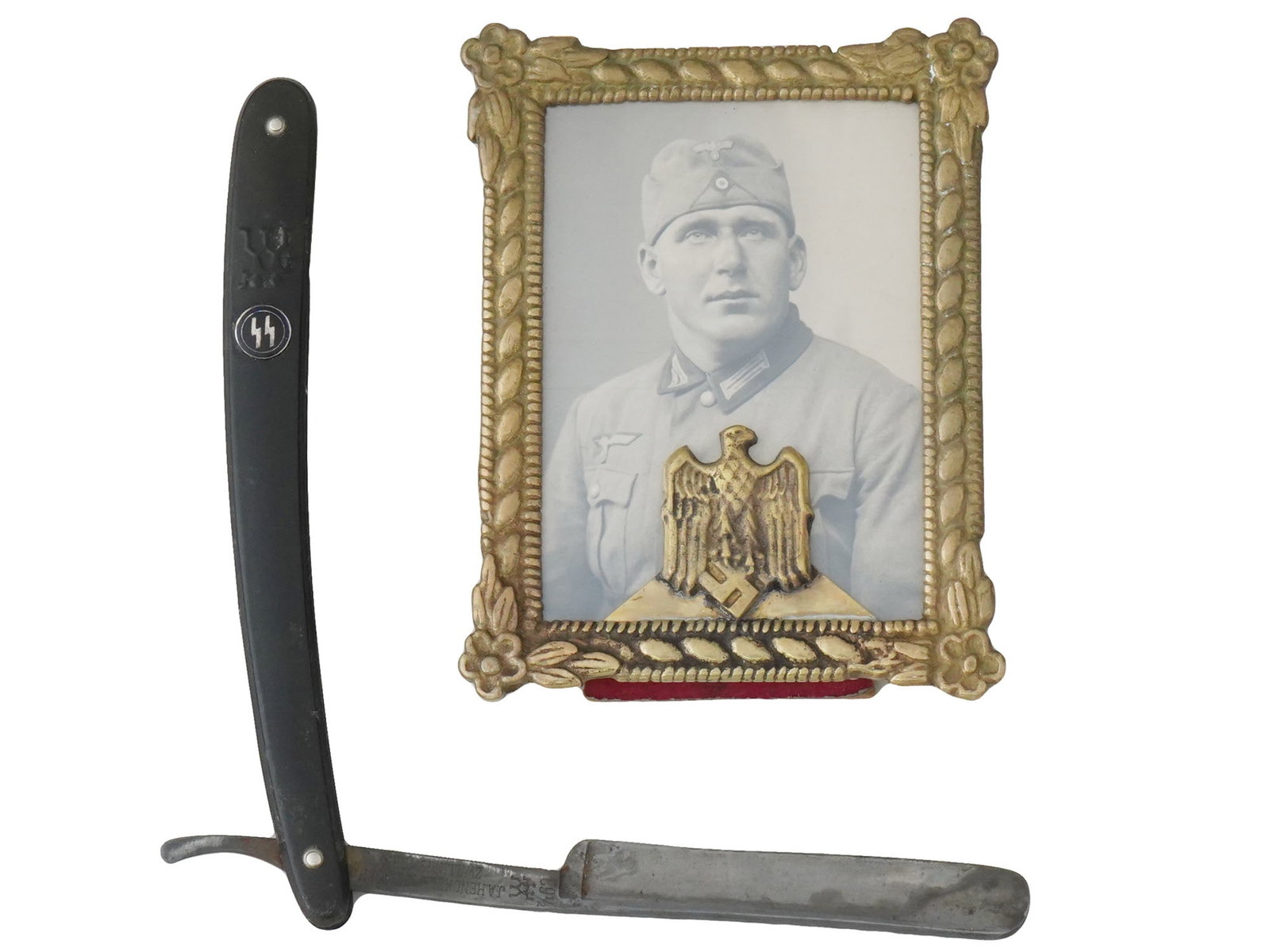 WWII NAZI GERMAN WAFFEN SS SHAVING RAZOR FRAMED PHOTO: A group of two WWII Nazi German items, including a Waffen SS officers straight shaving razor and a small photo portrait framed with a Nazi eagle clutching a swastika at the bottom. The framed photo sh