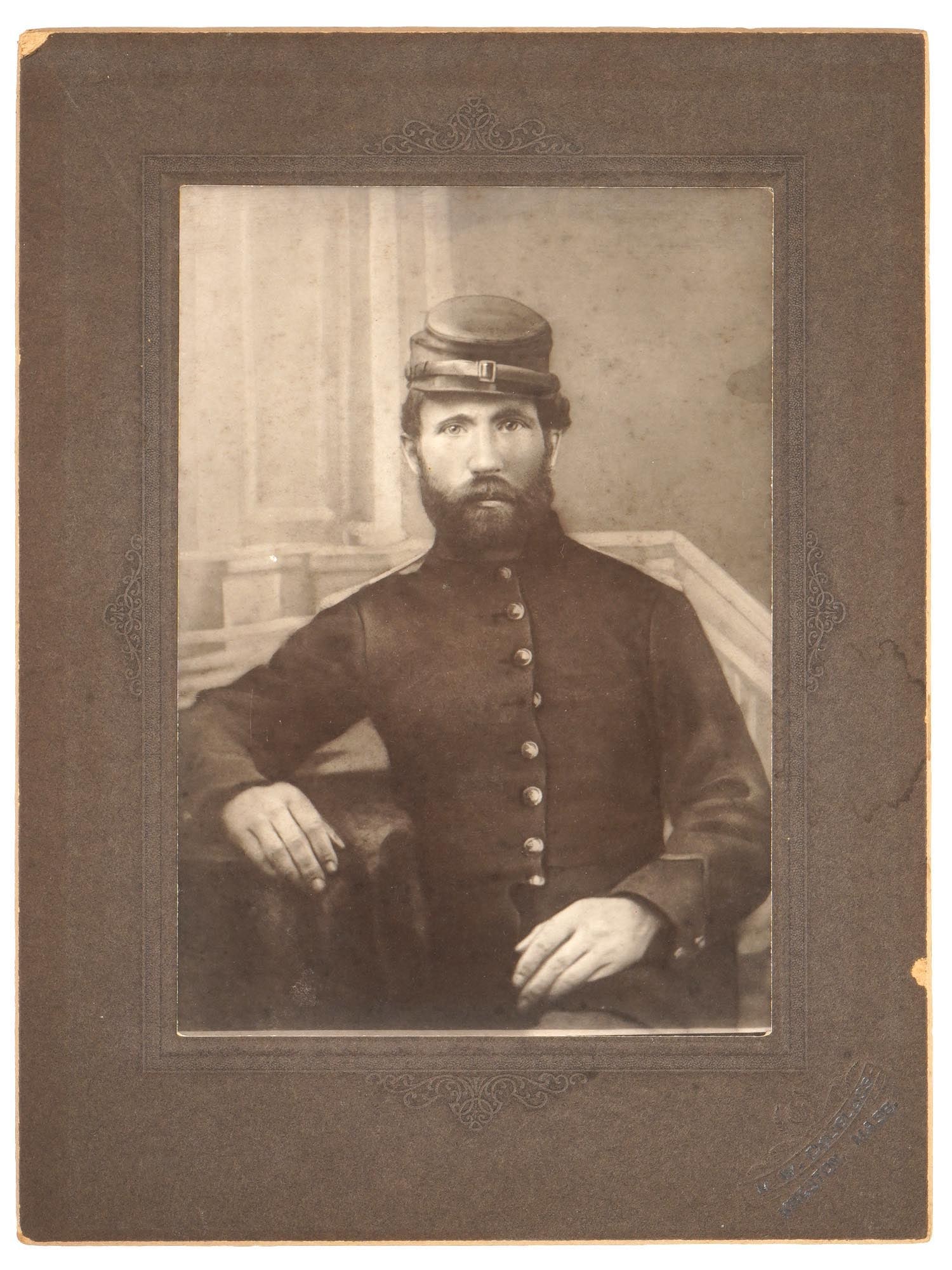 ANTIQUE AMERICAN PHOTO OF A CIVIL WAR SOLDIER: An antique late 19th-century American cabinet photograph, a portrait of a Civil War soldier. Private Peter Keevey, Oak St., Plympton Mass. Atelier hallmark on mat in the lower right, H.W. Douglas, Kin