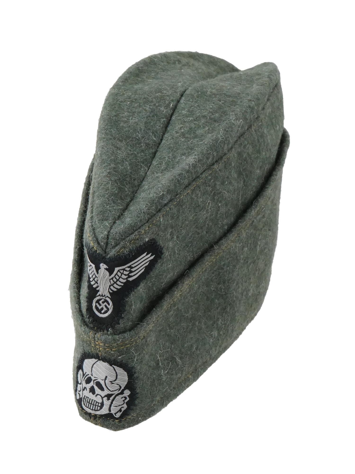WWII NAZI GERMAN SS TOTENKOPF OVERSEAS CAP: A World War II German EM SS overseas cap. Green wool narrow hat that could be folded flat and tucked into a belt or haversack. The front bears a complete set of SS insignia, with a Totenkopf below an 