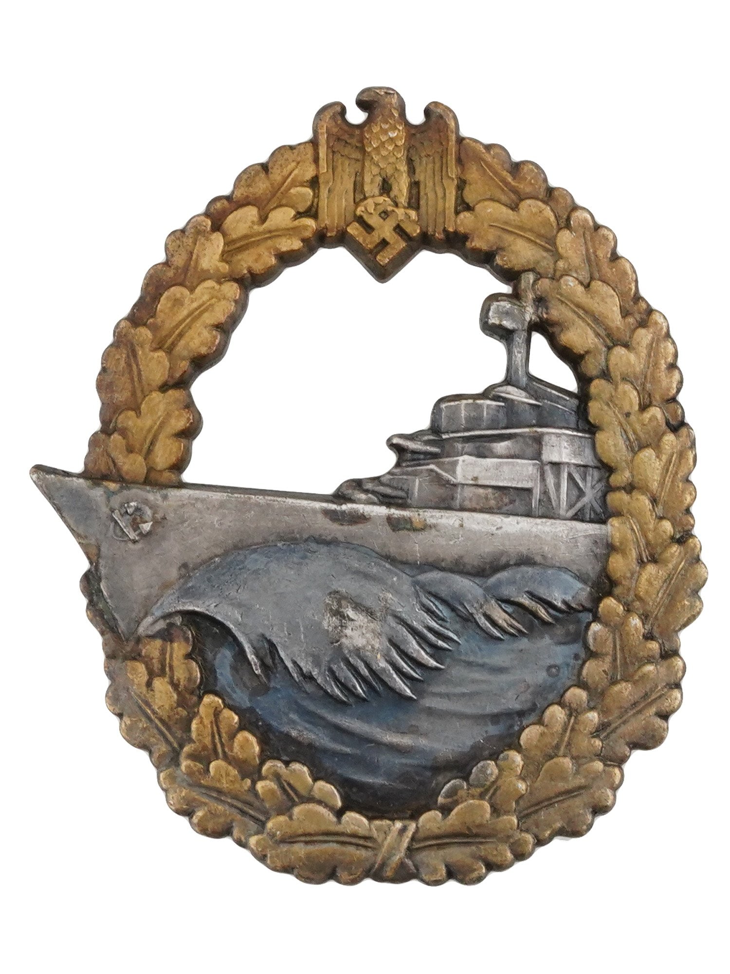 WWII NAZI GERMAN KRIEGSMARINE DESTROYER BADGE: A WWII Nazi German Kriegsmarine Destroyer badge, featuring an outer laurel wreath of oak leaves, with the national emblem of an eagle clutching a swastika at its apex. The central design showcases a s