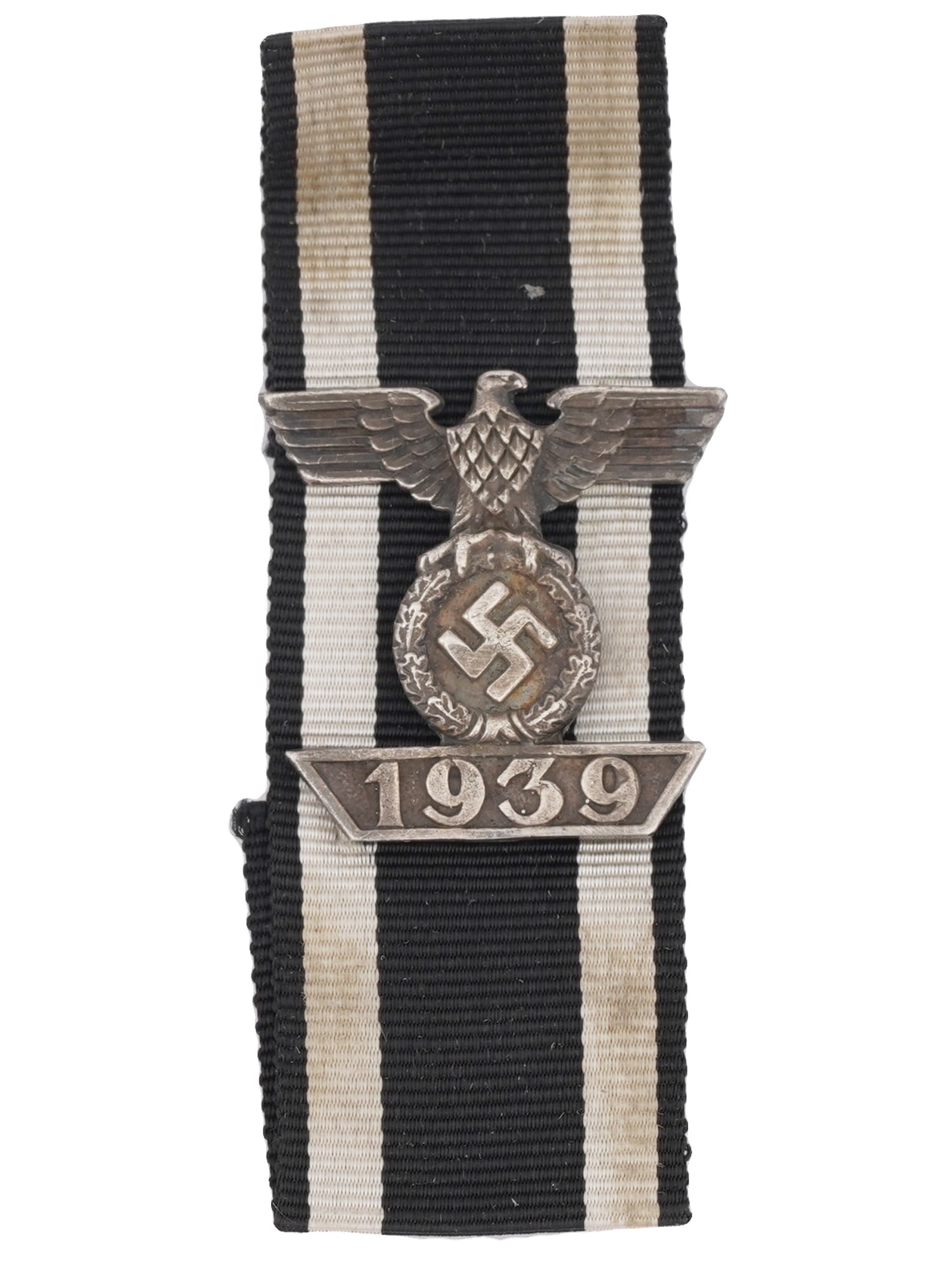 WWII NAZI GERMAN CLASP TO THE IRON CROSS 1939: A WWII Nazi German Clasp to the Iron Cross. It is a badge in the form of an eagle with an oak leaves wreath and a swastika in its claws, attached to fabric, and the number 1939 underneath it. The Clas