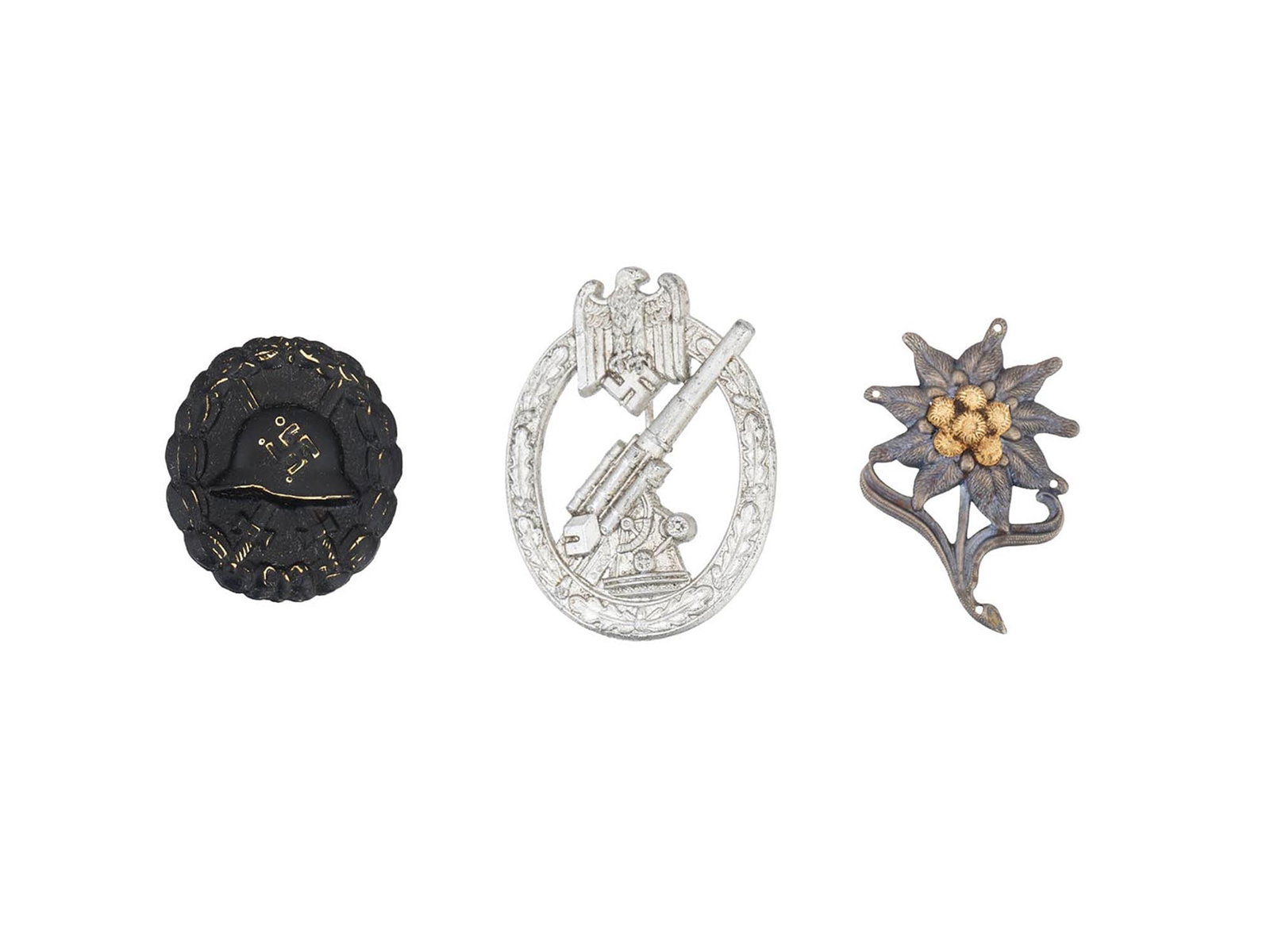 WWII NAZI GERMAN ANTIAIRCRAFT WOUND SS EDELWEISS BADGES: A group of three WWII Nazi German badges, including an Army Anti-Aircraft badge, a Wound badge, and a Waffen SS Edelweiss Flower cap badge. Second World War Nazi German Military Awards For Collectors.