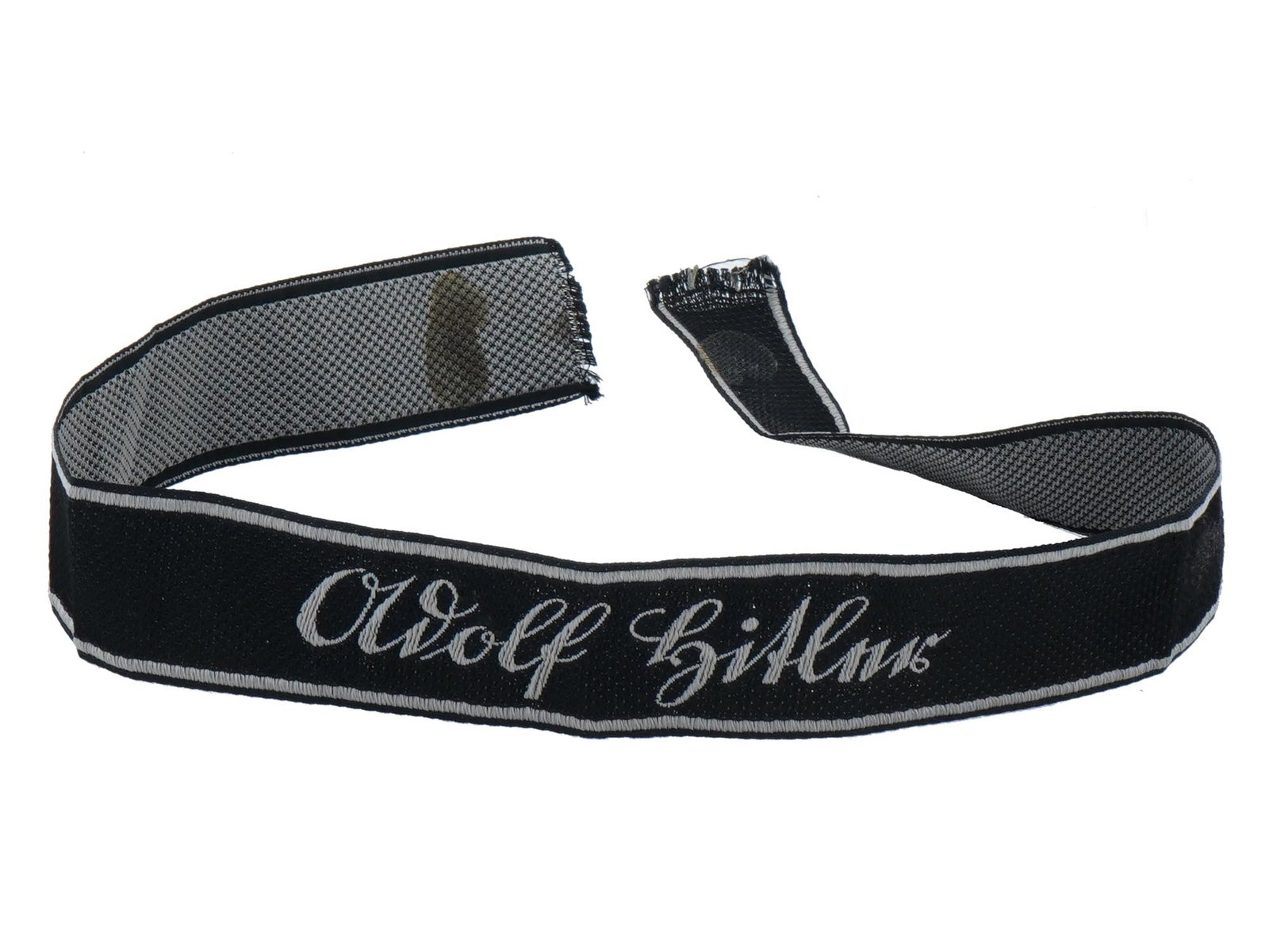 GERMAN WWII WAFFEN SS LSSAH ADOLF HITLER CUFF TITLE: A German WWII type Waffen SS Panzer Division Leibstandarte Adolf Hitler Cuff Title. The item features silver wire bullion embroidery on a black woven fabric band with silver wire edging. They were wor