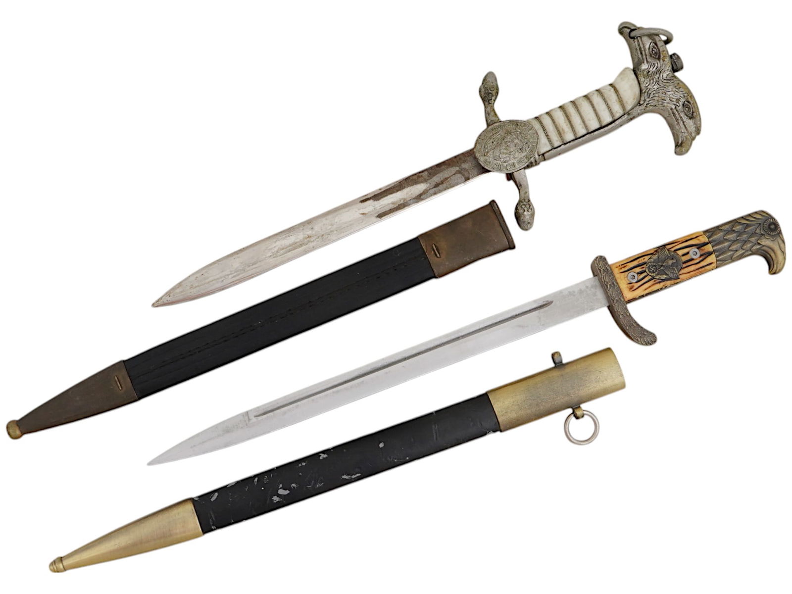 WWII NAZI GERMAN PRESENTATION BAYONET DAGGERS: A WWII Nazi German presentation bayonet dagger features a stainless-steel blade, a handle made of natural materials, an eagle’s head pommel, and a crossguard embossed with an oak leaf pattern. It co