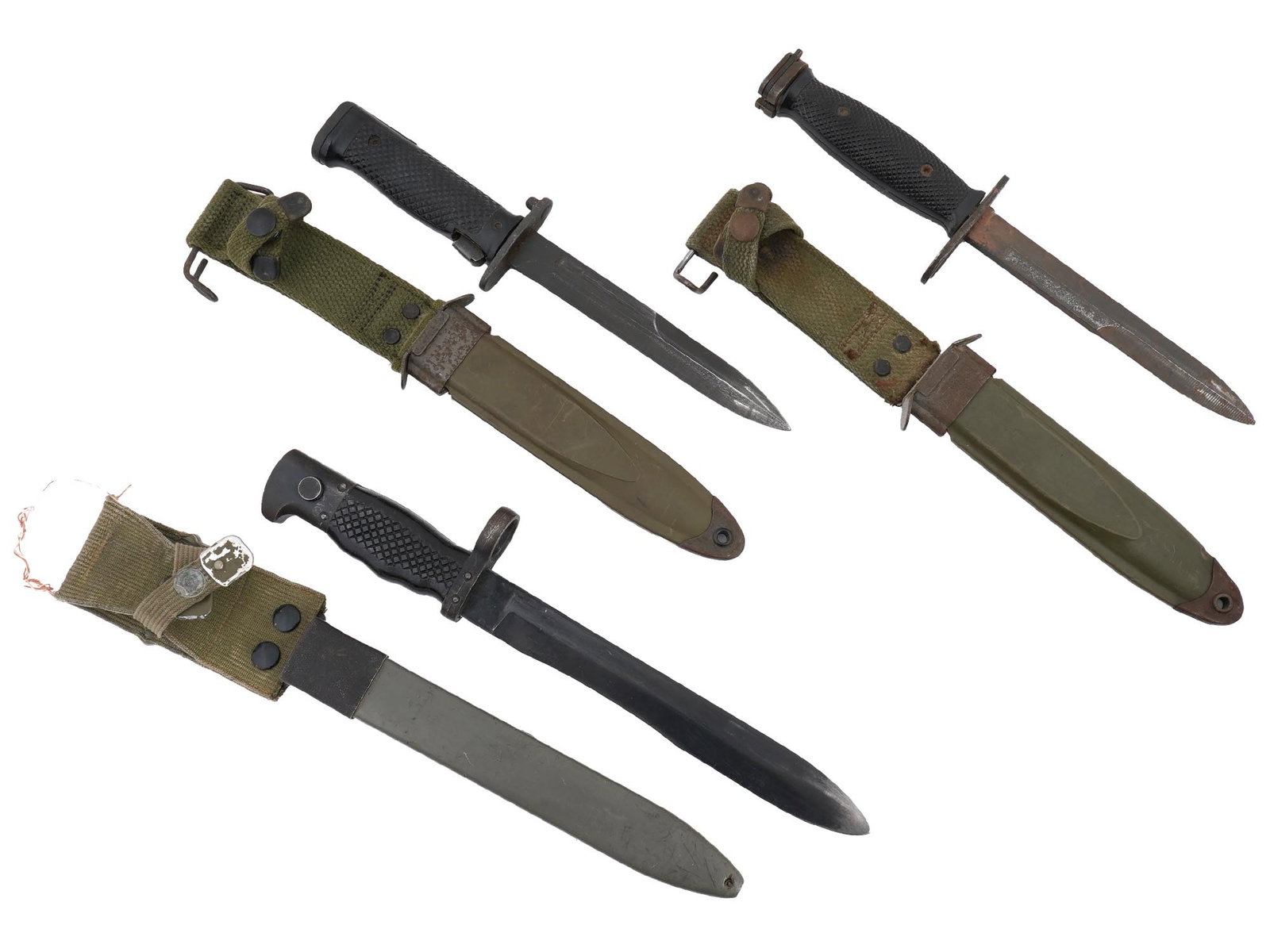 AMERICAN VIETNAM WAR AND SPANISH M1964 KNIFE BAYONETS: Three military knife bayonets. A Spanish M1964 knife bayonet for the CETME Model C selective fire battle rifle, complete with its original scabbard. The bayonet features a robust steel blade designed 