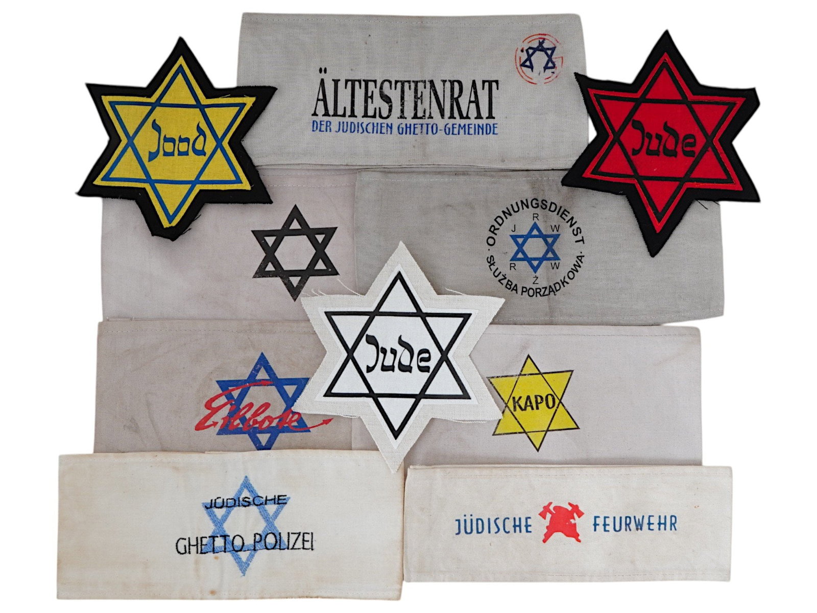 WWII NAZI GERMAN HOLOCAUST ARMBANDS STARS OF DAVID: A group of ten WWII Nazi German Holocaust-period items, including seven armbands and three Star of David badges. The armbands include those worn by Jewish Ghetto Police, Warsaw Ghetto police, Ghetto m