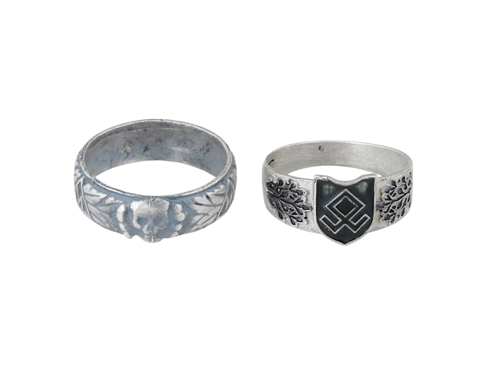 TWO WWII NAZI GERMAN WAFFEN SS SILVER RINGS: A group of two WWII Nazi German Waffen SS silver rings, comprising an SS Honor Ring Totenkopfring, traditionally awarded by Heinrich Himmler to select SS officers, and a ring representing the Waffen S