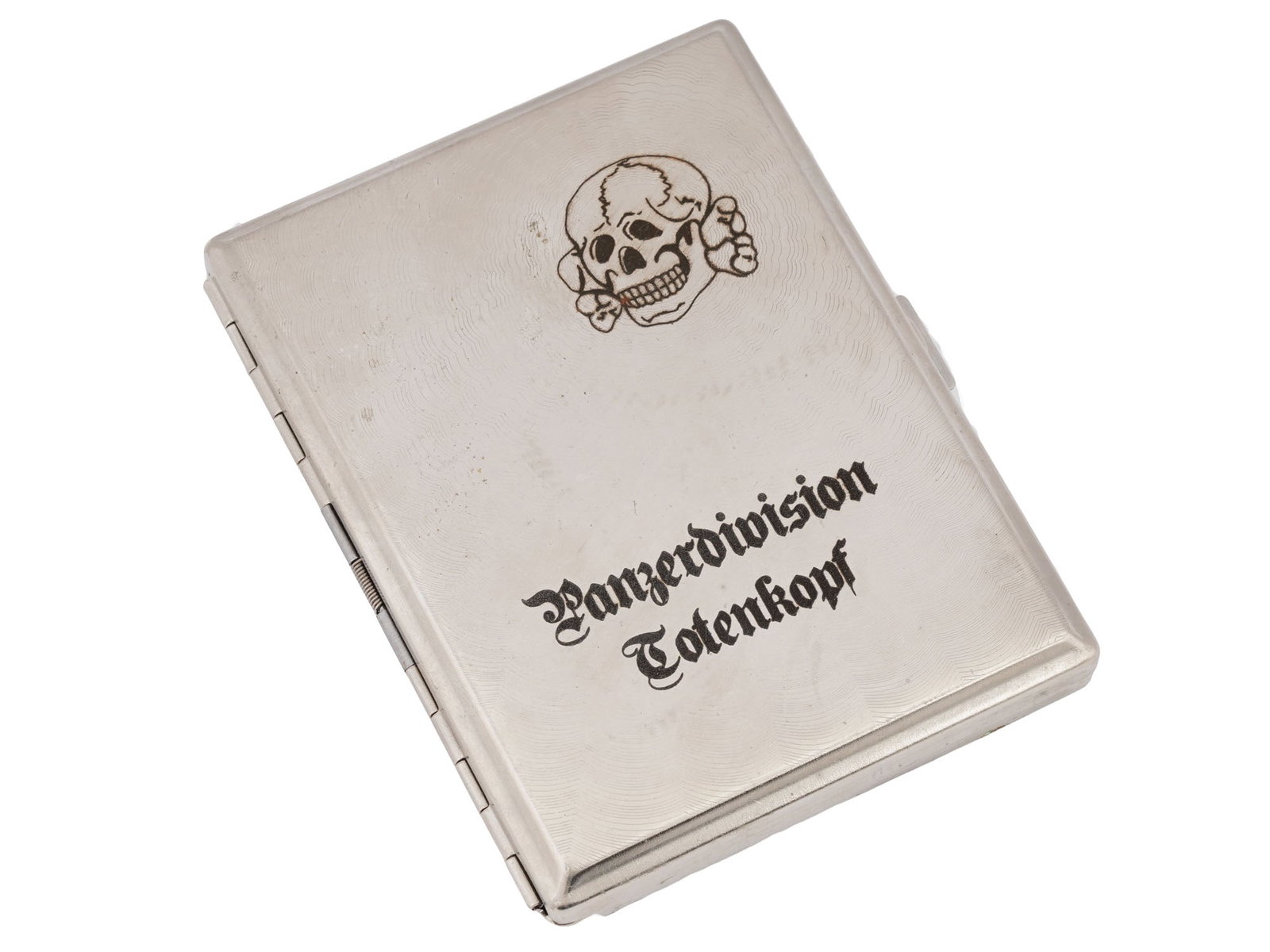 WWII NAZI GERMAN CIGARETTE CASE DIVISION TOTENKOPF: A WWII Nazi German cigarette case with a hinged cover, featuring an embossed skull with the inscription Panzerdivision Totenkopf. The interior includes two holder springs to secure cigarettes. The 3rd