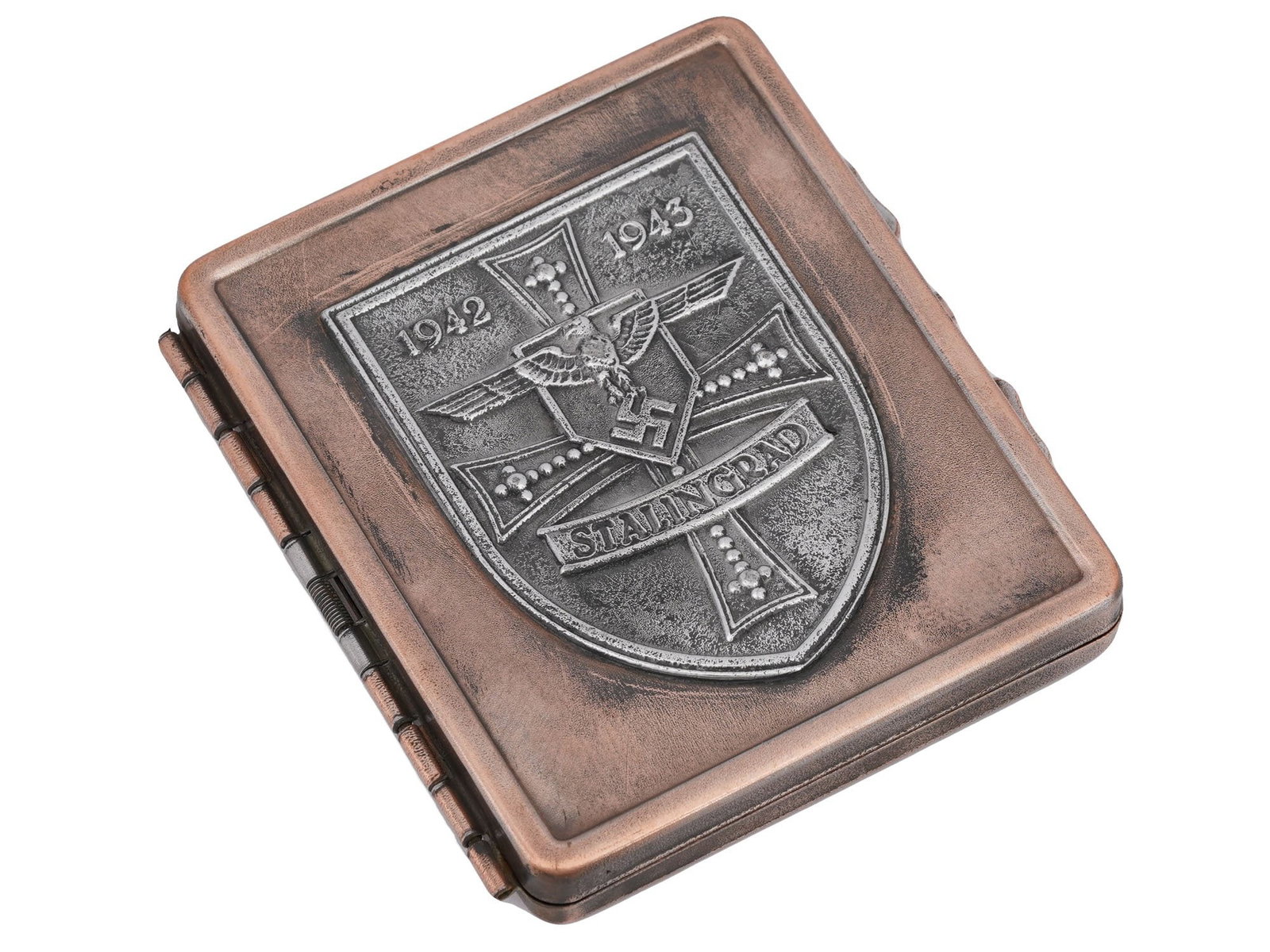 GERMAN WWII BATTLE FOR STALINGRAD CIGARETTE CASE: A World War II type German stainless steel cigarette case. The front cover is decorated with an embossed coat of arms which presents th German cross, Reichsadler with swastika, inscriptions 1942-1943,