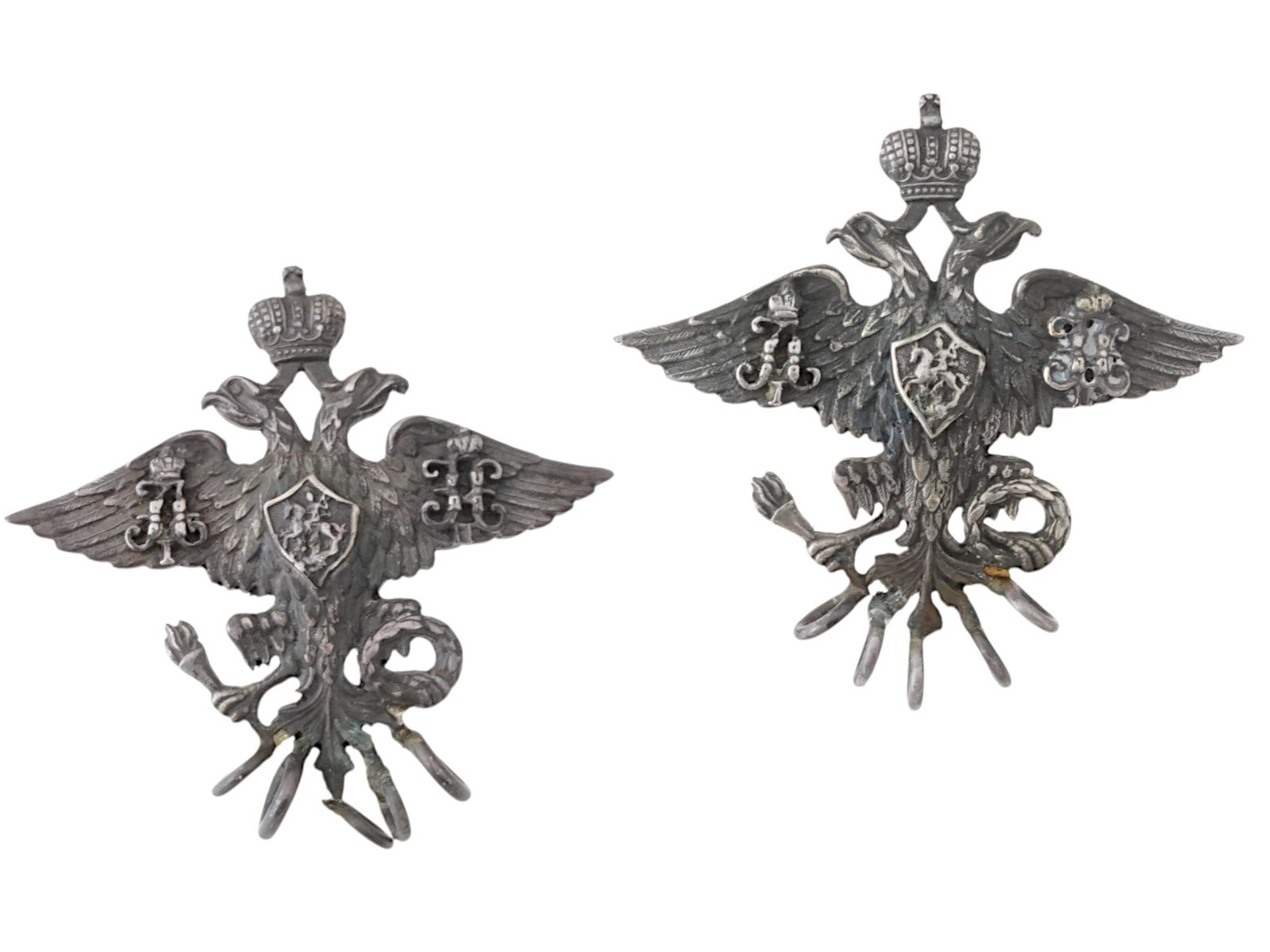 IMPERIAL RUSSIAN COSSACK OFFICERS SILVER BADGES: A pair of Imperial Russian military insignia, silver holders for Cossack officers gazyr. Crowned double-headed eagle with monograms of Emperors Alexander I and Nicholas II. Total Weight: 20.4 grams. A