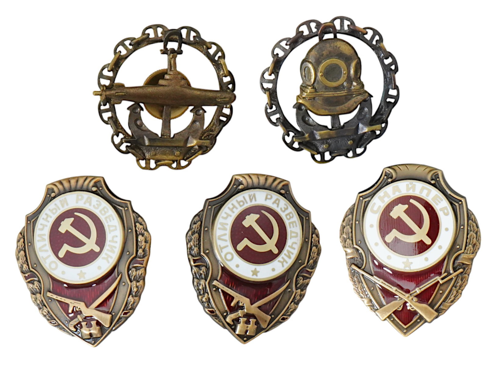 WWI AND WWII RUSSIAN MILITARY BADGES AND AWARDS: A group of five Russian military badges, including rare and historically significant pieces. The collection features a WWI Imperial divers badge, believed to be the first divers badge in history, and 