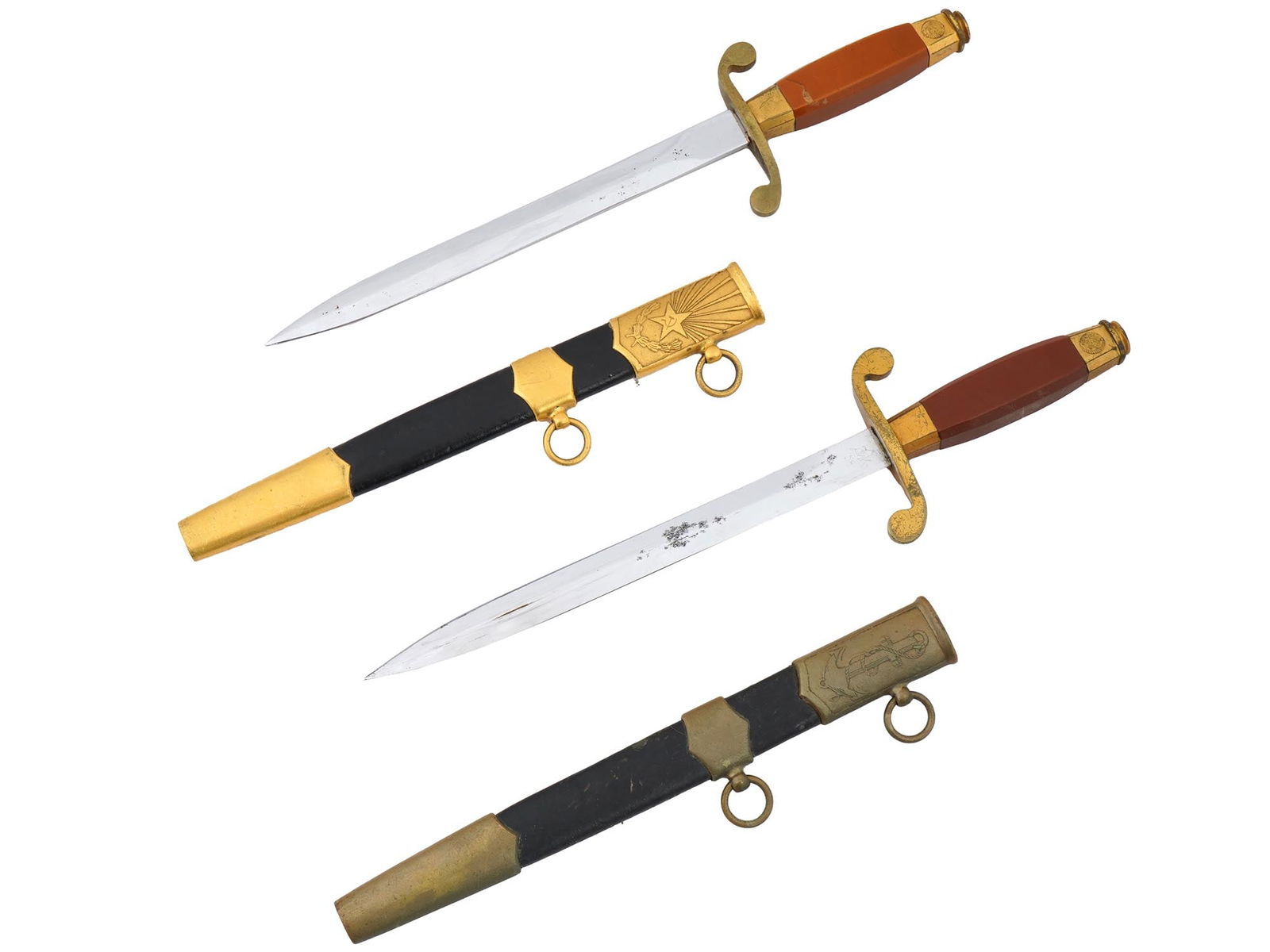 RUSSIAN SOVIET NAVAL AND ARMY DAGGERS WITH SCABBARDS: A pair of Russian Soviet naval and army daggers, elements of the dress uniform for officers in the Soviet Union. Both daggers feature edged steel blades marked at the ricasso and crossguards with an S