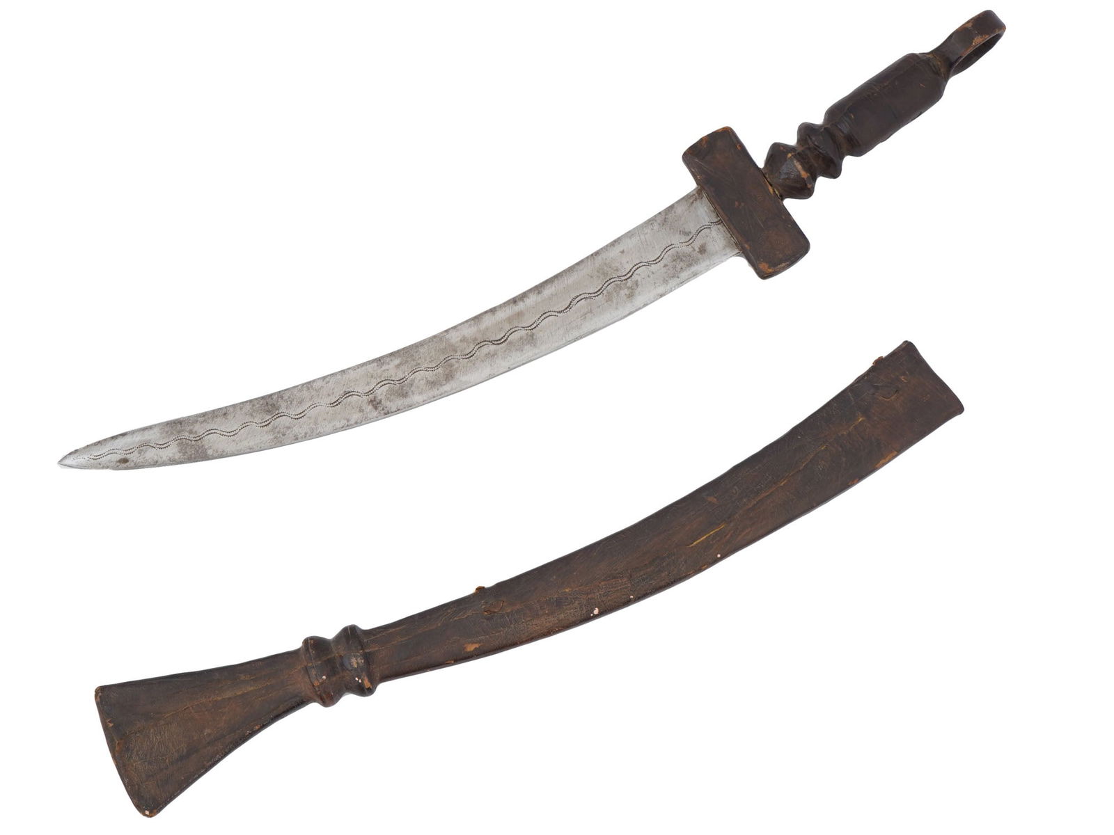 TRADITIONAL AFRICAN DAGGER WITH SCABBARD: An African dagger featuring a curved steel blade, intricately decorated with a wavy pattern along its length. The daggers hilt is carved from wood, shaped into a figural design. The wooden scabbard is