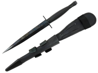 AUSTRALIAN ARMY COMMANDO FAIRBAIRN AND SYKES DAGGER: An Australian Army Commando Fairbairn and Sykes dagger with its original black leather sheath. This classic combat knife features protective blackened metal fittings, a ribbed hand grip, and a flat ov