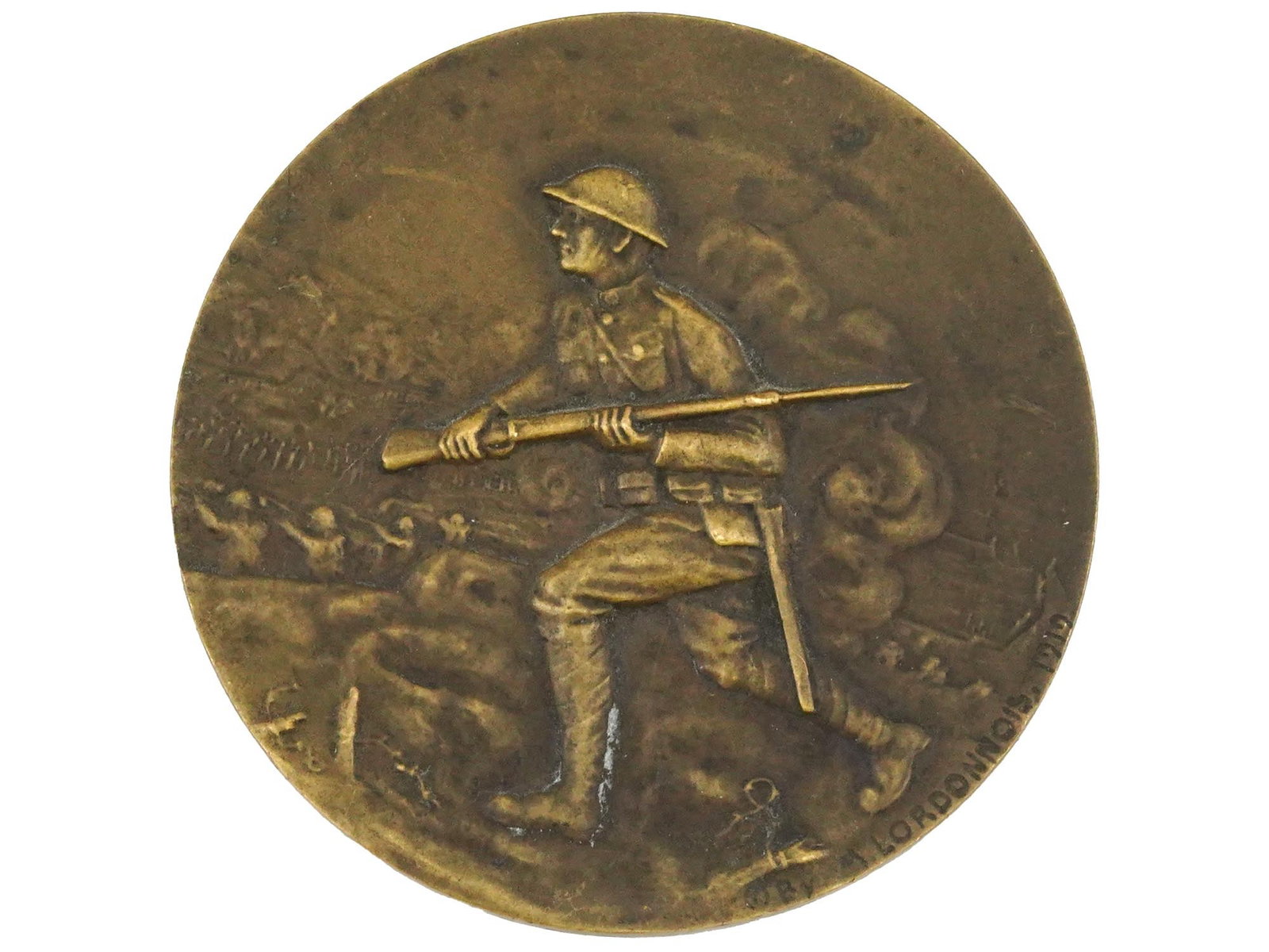 WWI FRENCH AMERICAN DOUGHBOY FIGHTING BRONZE MEDAL: A WWI French-American Doughboy Fighting in France bronze medal, designed by Marcel Prosper Lordonnois. The obverse features a helmeted, bayonetted rifle-toting soldier rushing into battle, with smalle