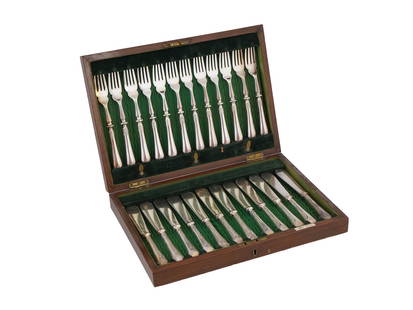 BRITISH WALKER AND HALL SILVER KNIVES AND FORKS IOB: A set of silver plated fish knives and forks manufactured by Walker and Hall, a British silversmith. A total of 24 pieces. The set is arranged in a wooden box, which is lined with green velvet. The kn
