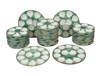 ANTIQUE FRENCH LONGCHAMP MAJOLICA OYSTER PLATES SET: A set of glazed earthenware oyster plates by Longchamp, a French ceramics manufacture established in 1832. Ca. early 20th century. A total of 31 medium plates and 4 larger plates. Aqua green ground co