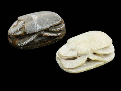ANCIENT EGYPTIAN CARVED STONE SCARAB AMULET BEADS: A lot of two ancient Egyptian carved stone scarab amulet beads of naturalistic form. The underside bears incised symbols. According to the ideas of the ancient Egyptians such amulets served to protect