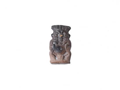 ANCIENT EGYPTIAN LATE PERIOD STONE GOD BES PENDANT: An ancient Egyptian late period hand carved stone pendant in the shape of the god Bes with engraved details. Circa 700 to 200 BC. God Bes was worshiped in ancient Egypt as the protector of homes, moth