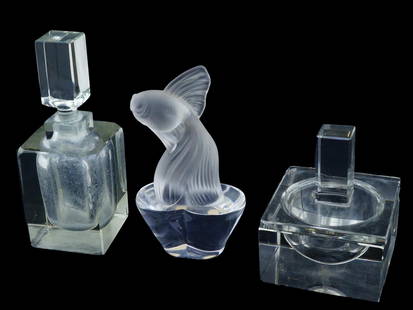 FRENCH SEVRES CRYSTAL PERFUME BOTTLES AND FISH FIGURINE: A lot of three vintage French Sevres crystal items, two Art Deco perfume bottles, and a fish figurine. Art Deco perfume bottles with geometric shapes and large stoppers. The frosted crystal figurine i