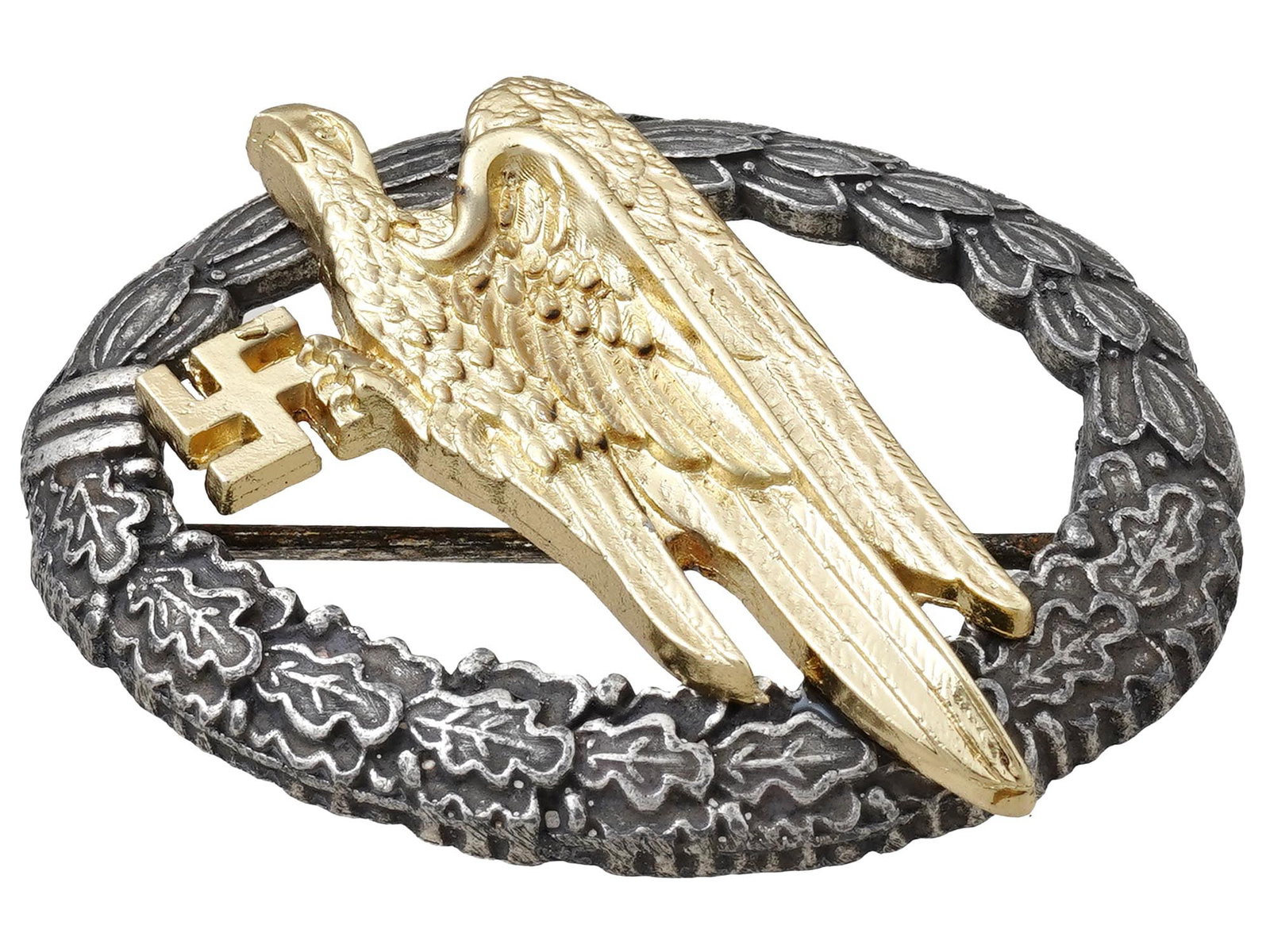 WWII TYPE NAZI GERMAN NSDAP LUFTWAFFE PARATROOPER BADGE: A WWII type Nazi German Third Reich Luftwaffe Army Paratrooper badge. The badge features a gold tone relief image of a diving eagle at the center surrounded by a laurel and oak leaves wreath. The wrea