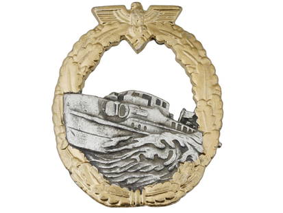 WWII MODEL NAZI GERMAN KRIEGSMARINE S BOAT BADGE: A WWII model Nazi German military decoration, Kriegsmarine S Boat badge. The badge depicts a shorter high silhouette S boat with an outer gold laurel wreath of oak leaves with the German Eagle at the