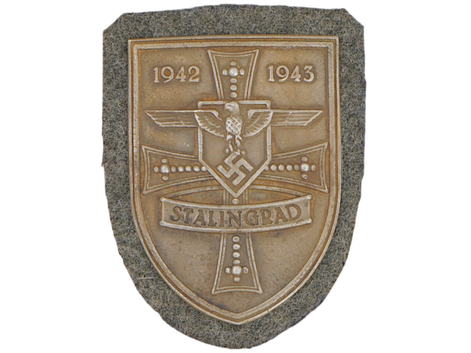 GERMAN WWII TYPE STALINGRAD SHIELD: A WWII type Nazi German military decoration, the Stalingrad Shield. The shield shaped badge features an eagle with swastika, a cross and inscription 1942 1943 Stalingrad. The Battle of Stalingrad was 