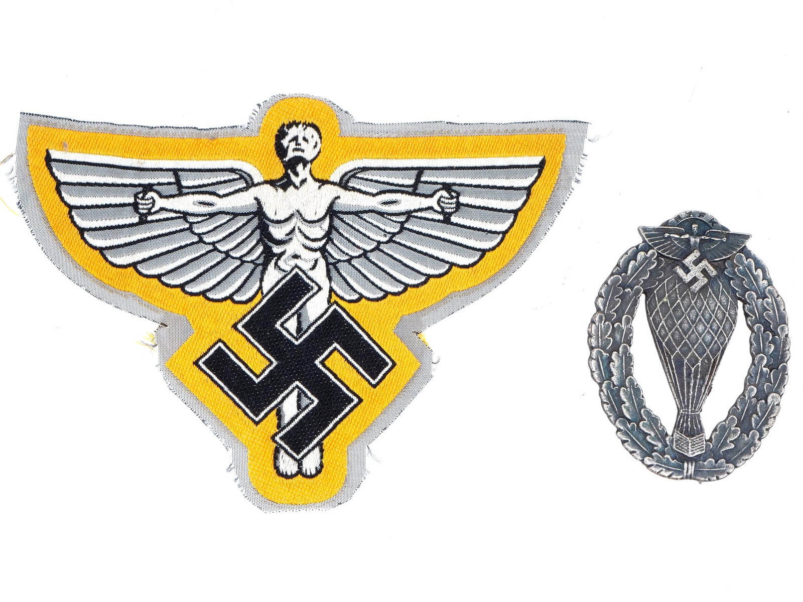 WWII GERMAN NSFK PATCH AND ALLOON PILOTS BADGE: A lot of 2 WWII German NSFK items, a badge and a patch. The lot includes a cloth sleeve patch of the NSFK with an image of a winged man with a swastika against a yellow background. And a Balloon Pilot