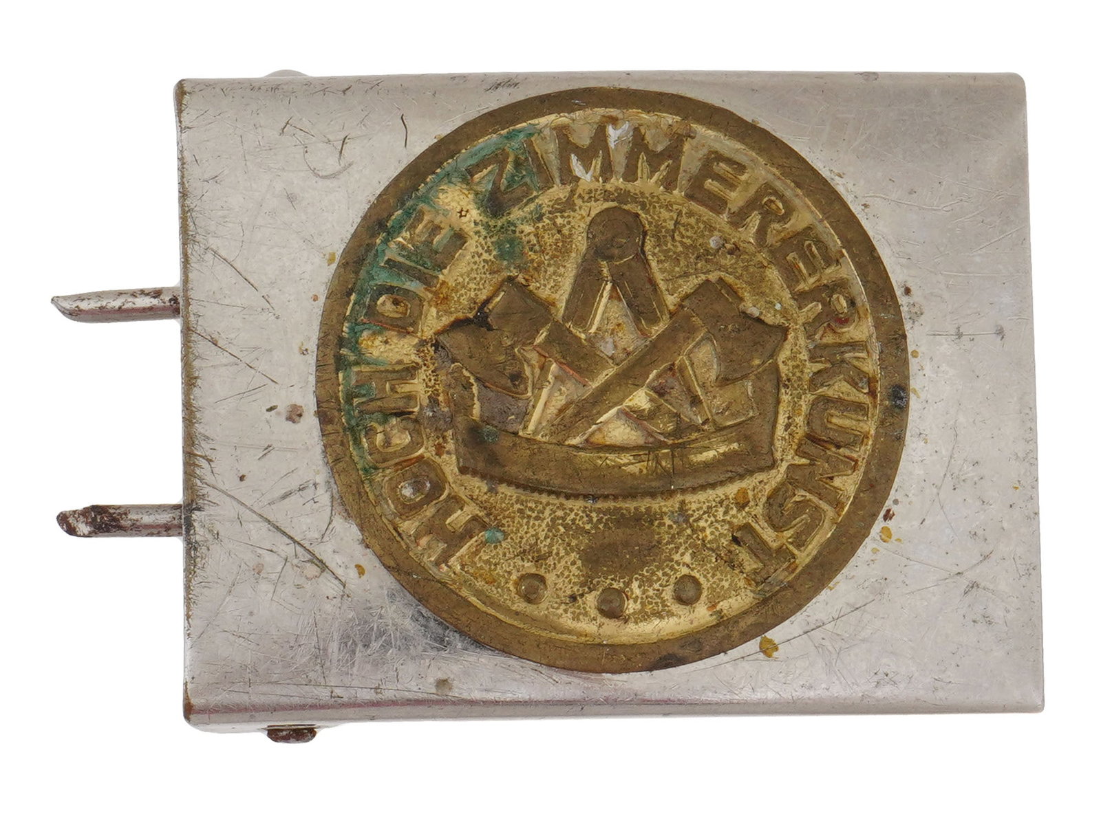 WWII NAZI GERMAN MODEL MASONRY MILITARY BELT BUCKLE: A WWII Nazi German model belt buckle. The buckle is adorned with an insignia to the center and inscribed, Hoch Die Zimmererkunst, High The Art of Carpentry, being used by the Masonry trade unions duri