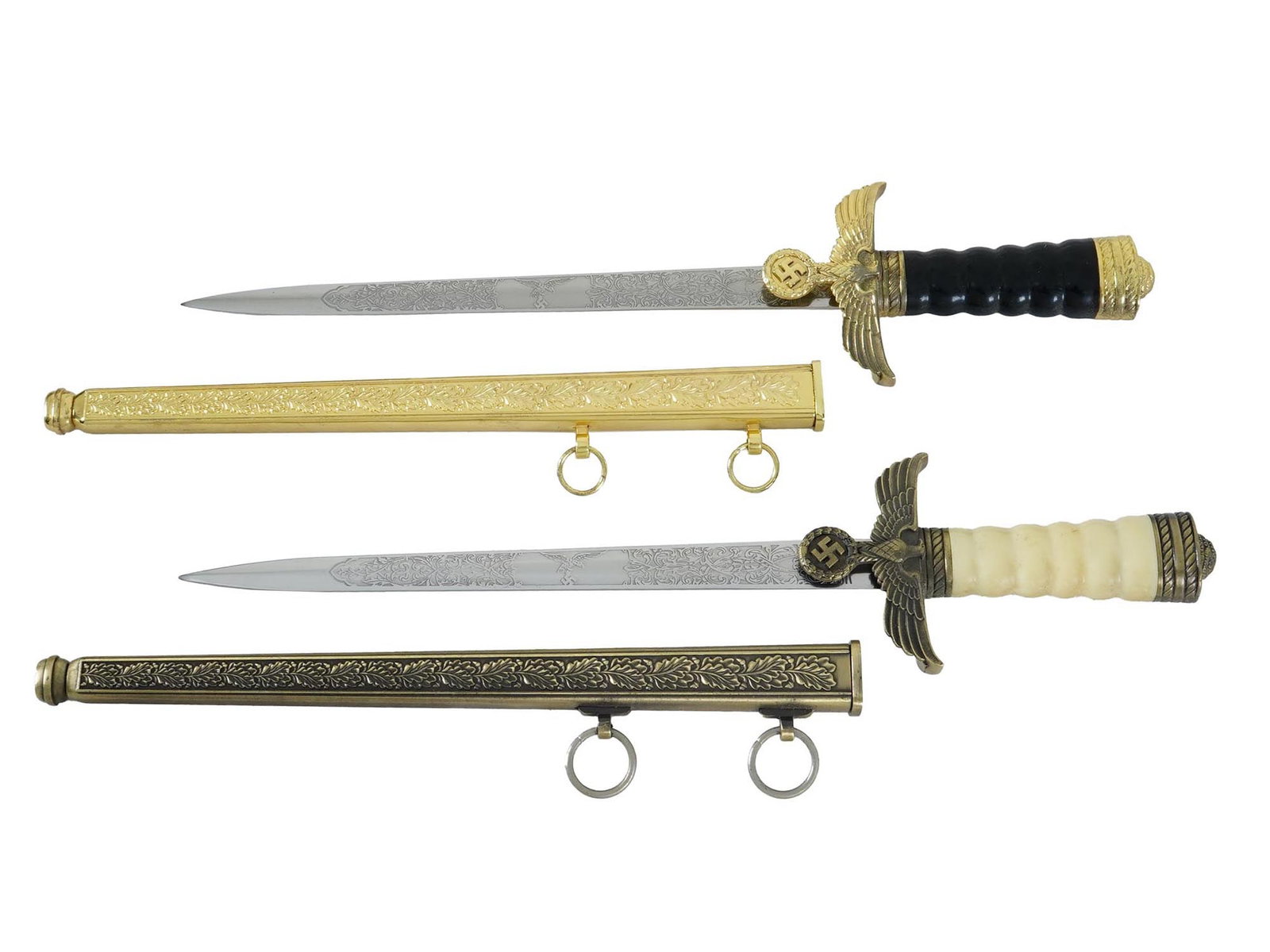 GERMAN WWII TYPE LUFTWAFFE MINIATURE SWORDS: A pair of World War II model Nazi German Luftwaffe daggers or miniature swords. Stainless steel straight double-edged blade with etched ornaments and Luftwaffe eagles. Twisted grip with Reichsadler cr