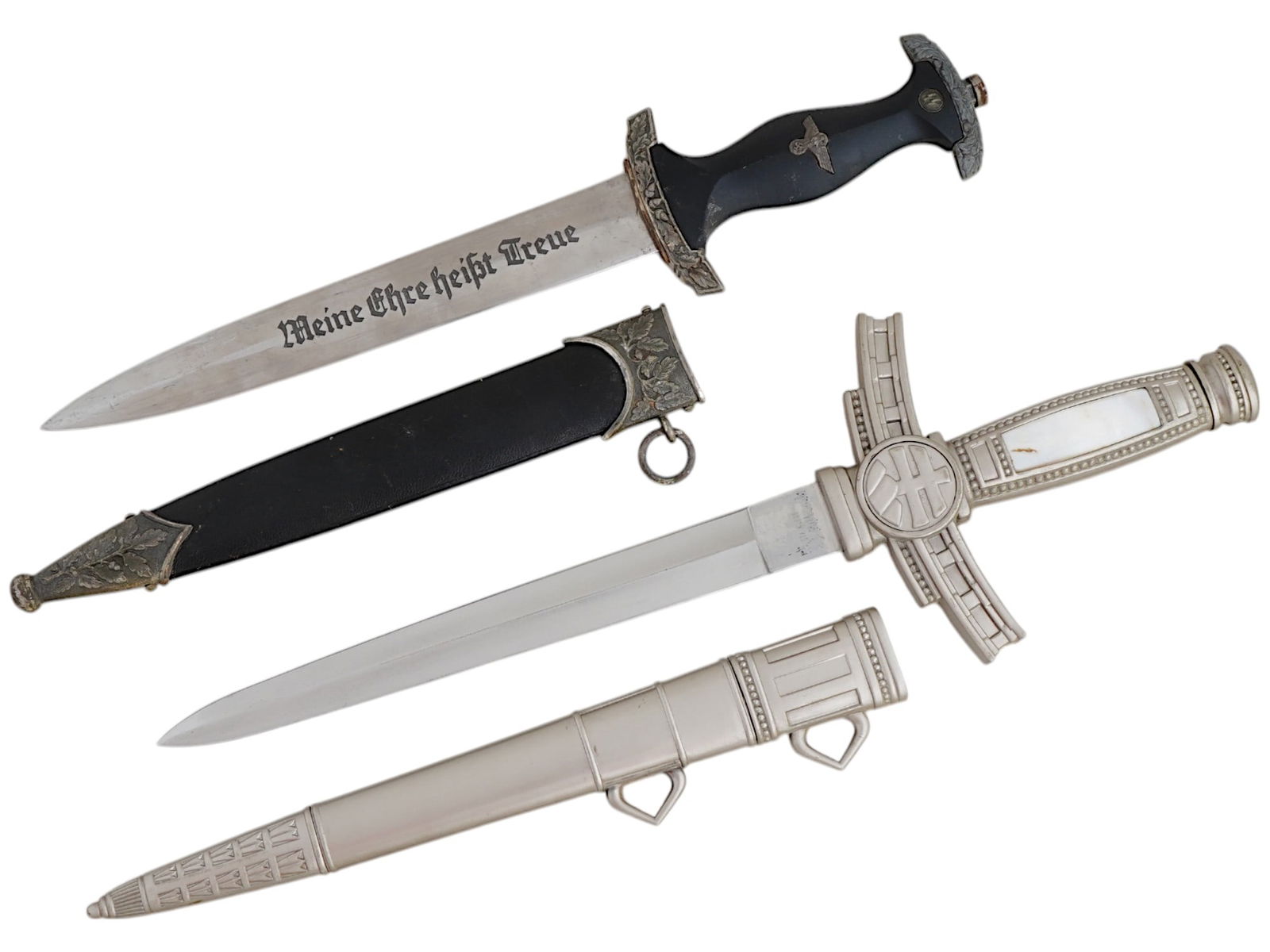 LOT OF NAZI GERMAN MODEL SS AND SLOVAKIAN DAGGERS: A lot of two WWII type daggers. The first: a WWII model Nazi German SS Ehrendolch, or honor dagger. The stainless steel blade is garnished with etching, the motto Meine Ehre Heisst Treue, Loyalty is M