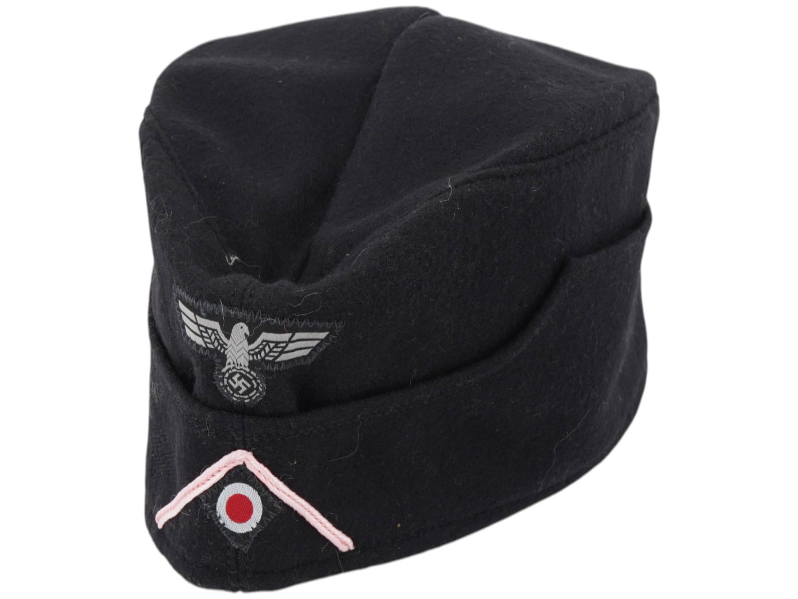 WWII NAZI GERMAN PANZER GRENADIER OVERSEAS CAP: A World War II German Panzer Grenadier EM SS overseas cap. Black wool narrow hat that could be folded flat and tucked into a belt or haversack. The front bears a complete set of Panzer Grenadier insig