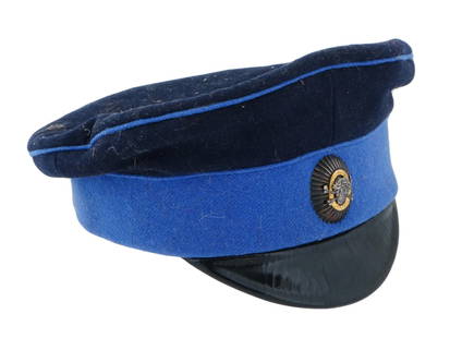 RUSSIAN CIVIL WAR OFFICERS HAT WITH SKULL BADGE: A 1918 Russian Civil War Officers hat belonged to Alekseev. The hat features a dual tone color scheme of dark blue and lighter blue. The outer fabric appears to be a soft wool blend. Prominently displ