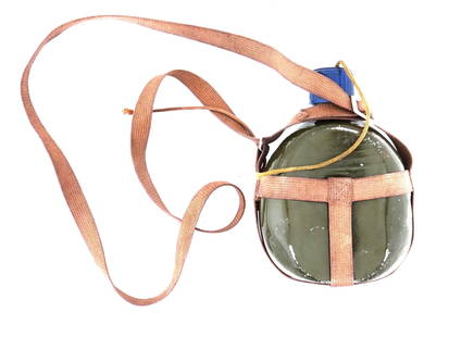 WWII JAPANESE SOLDIER WATER BOTTLE WITH BELT STRAP: A WWII Japanese soldier water bottle. Featuring a durable canvas belt strap for easy carrying and a plastic lid. Circa 1941. Second World War Japanese Military Collectibles. Dimensions: H 7 1/2 in. Al