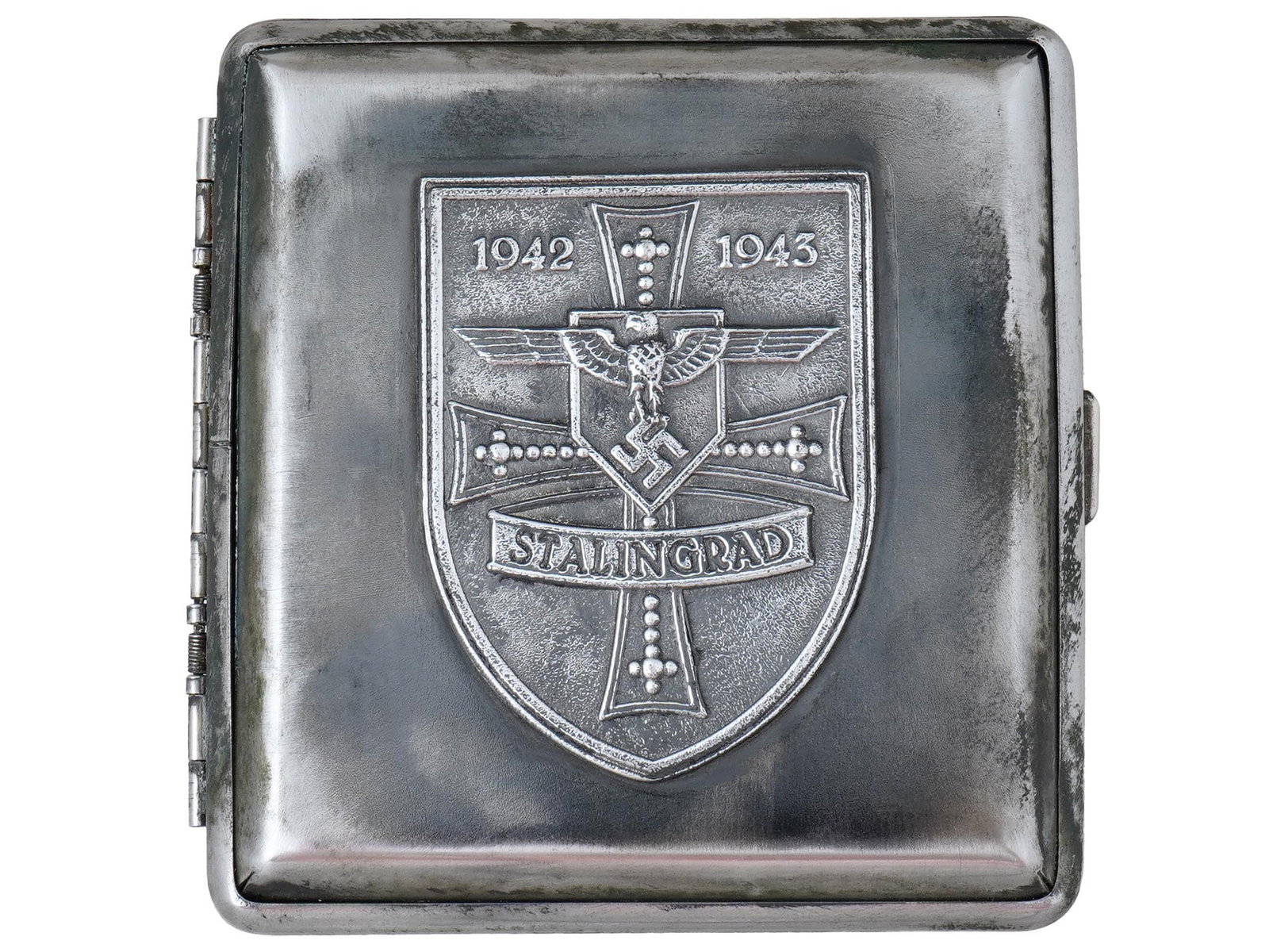 GERMAN WWII TYPE BATTLE FOR STALINGRAD CIGARETTE CASE: A World War II type German Battle for Stalingrad steel cigarette case. The front cover is decorated with an embossed coat of arms which presents th German cross, Reichsadler with swastika, inscription