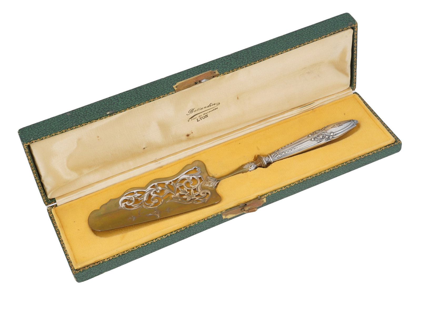 WWII ADOLF HITLER MONOGRAMMED CAKE SERVER IOB: A WWII French Adolf Hitler cake server. The spatula is partially gilt and decorated with openwork engraved flower motifs. The handle has embossed decorations and etched initials A H for Adolf Hitler. 