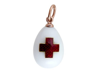 RUSSIAN GOLD ENAMEL JADE RED CROSS EGG PENDANT: A Russian Easter egg pendant made of polished white jade with 14K gold fittings. The obverse is garnished with an enamel overlayed red cross. Hallmarks of the 56 gold standard and makers marks are on