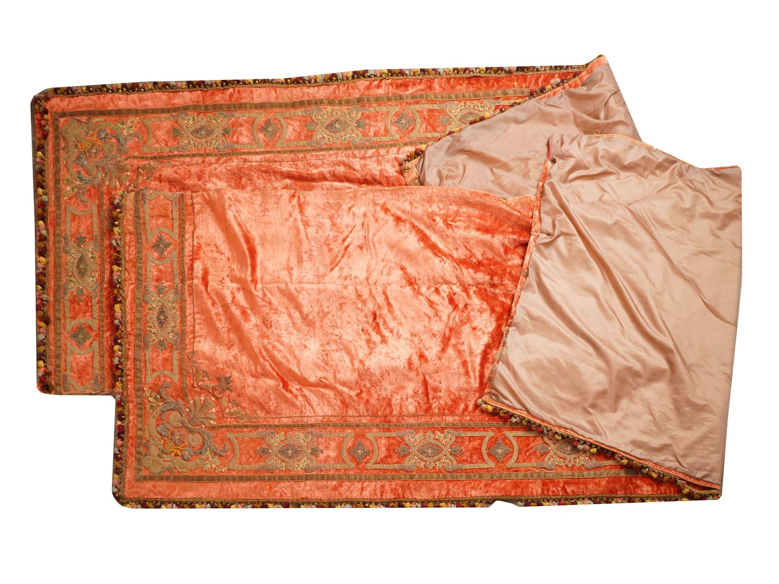 PAIR OF ANTIQUE 19TH CEN ITALIAN VELVET BULLION DRAPES: A pair of antique 19th century Italian velvet bullion drapes. The main color is a vibrant coral orange hue, adorned with geometrical and floral motifs. The edges are decorated with tassels of various 
