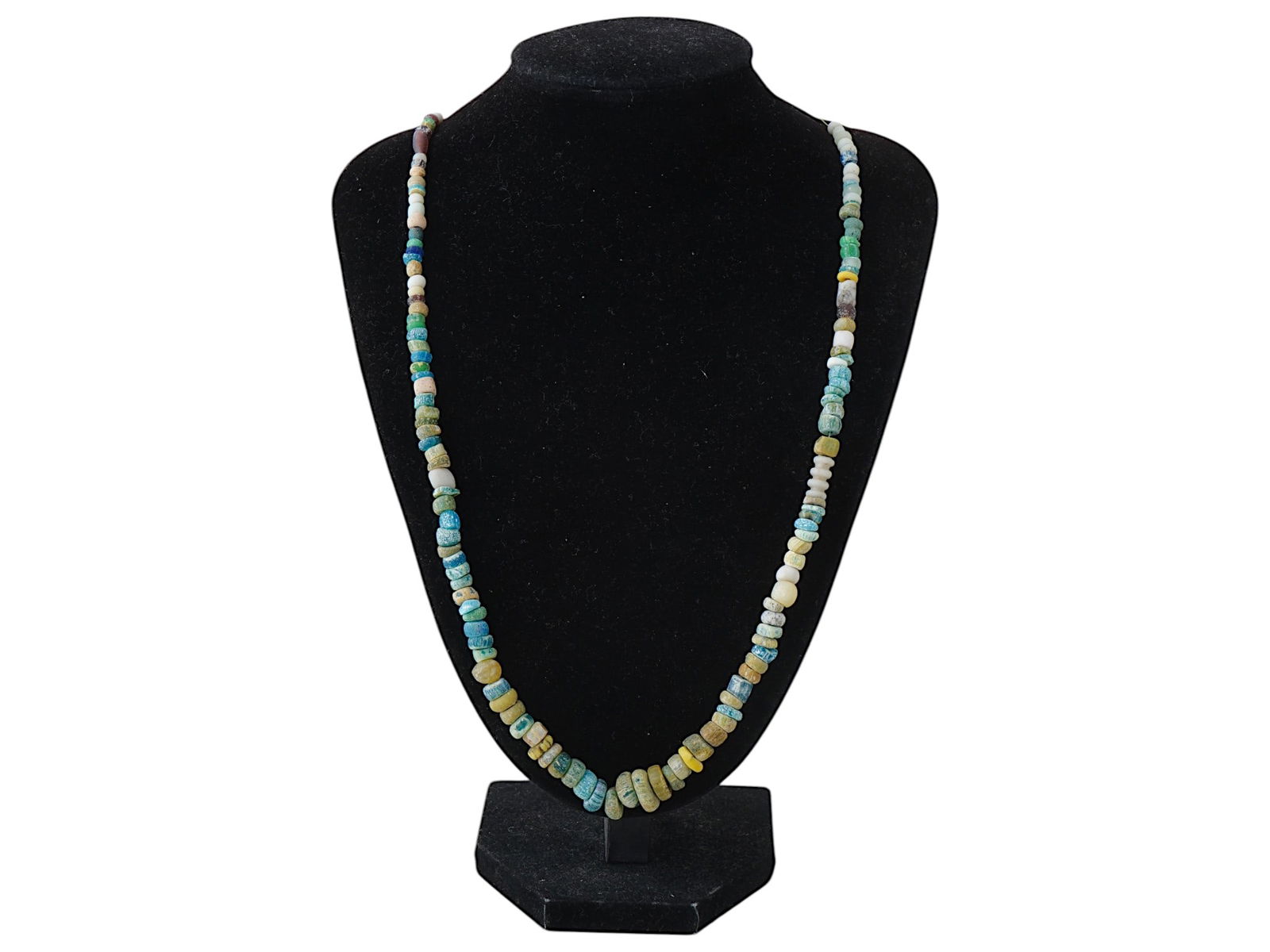 ANCIENT ROMAN MULTICOLOR GLASS BEAD NECKLACE: An ancient Roman glass bead necklace dating from 100 to 300 AD. Features a variety of colored glass beads, each uniquely shaped, exemplifying the craftsmanship and artistry of Roman glassmakers during