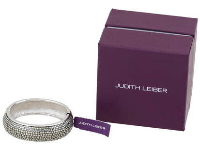 JUDITH LEIBER PAPARAZZI GLITZ UP BANGLE BRACELET IOB: A vintage silver-tone hinged bangle bracelet handcrafted by Judith Leiber Jewelry. Paparazzi Glitz Up collection. One half of the bracelet is garnished with pave Swarovski crystals, the other half is