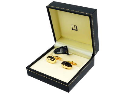 VINTAGE DUNHILL GILT STERLING SILVER GOLF CUFFLINKS: A pair of vintage Alfred Dunhill gilt sterling silver cufflinks with an embossed figure of a golfer with a club in black enamel. Hallmarked with Dunhill and sterling silver standard marks. Comes with