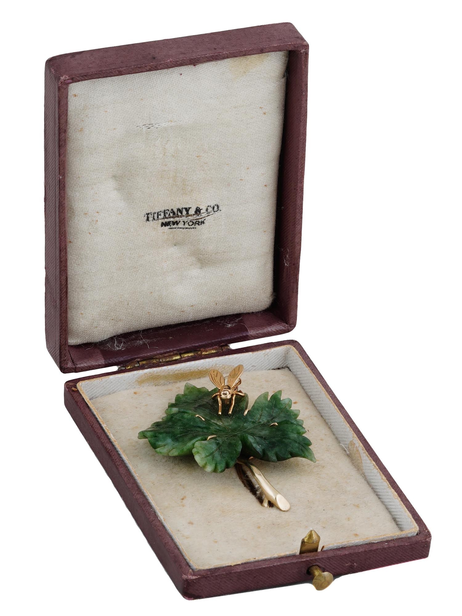 MID CENTURY TIFFANY AND CO GOLD JADE PEARL BROOCH: A vintage mid century brooch by Tiffany and Co. The brooch is designed as a green jade leaf with a 14k yellow gold and pearl fly. Hallmarked on the back side: 14K, Tiffany and Co. Comes with a branded