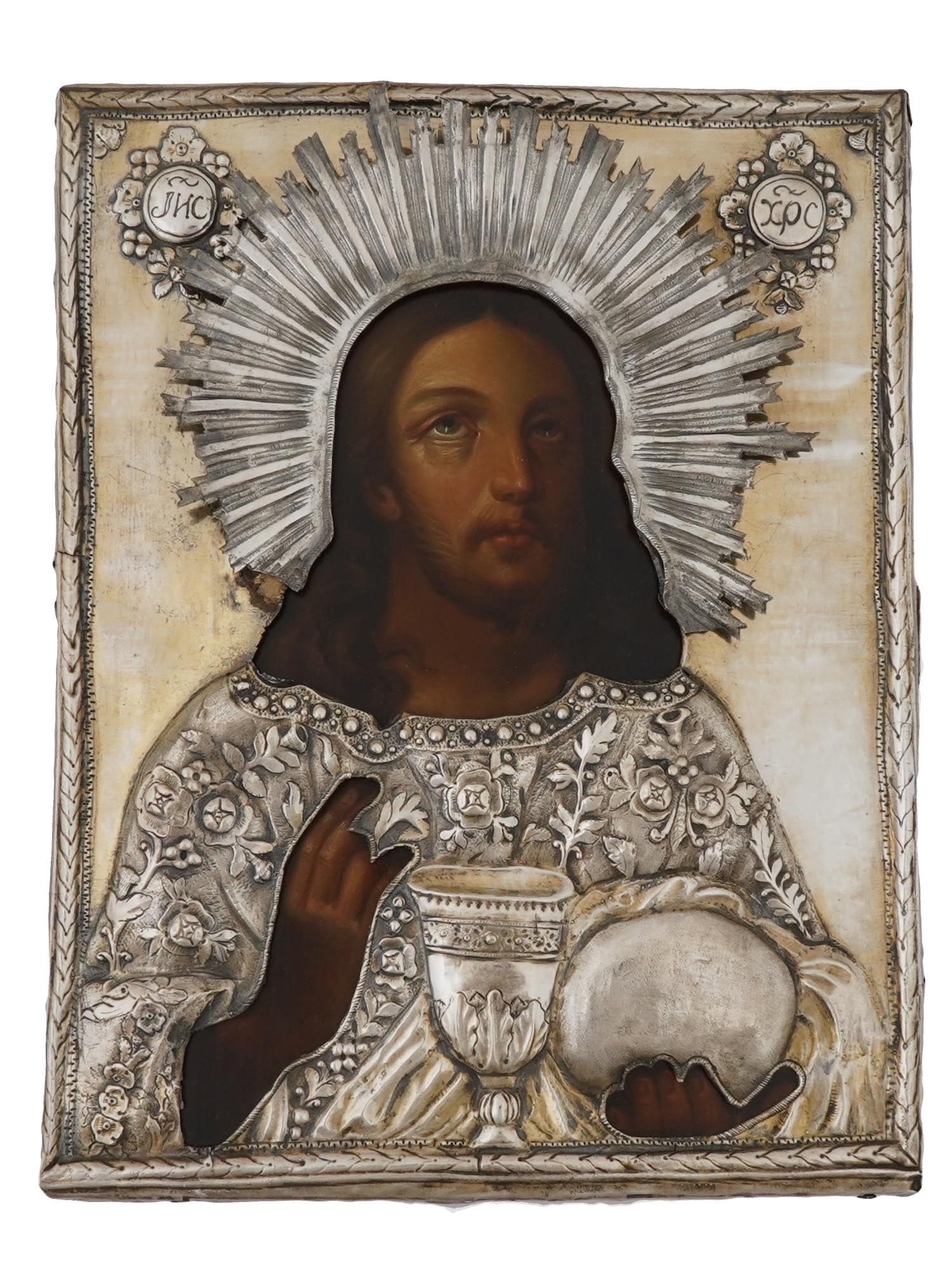 ANTIQUE 19TH C RUSSIAN ORTHODOX JESUS SILVER ICON: An antique early 19th century Russian Orthodox icon of the Jesus Blessing Bread and Wine. Mixed media painting: egg tempera, gesso, and levkas on a wood board. Adorned with an embossed silver oklad. H