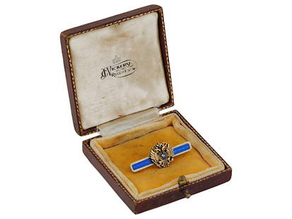 RUSSIAN EAGLE 14K GOLD AND ENAMEL DIAMOND TIE PIN: A Russian 14K Gold and enamel tie pin. The pin is adorned with a gilded double headed eagle, encrusted with a Diamond to the center. The pin is covered with enamel in a blue shade. Marked with a Russi
