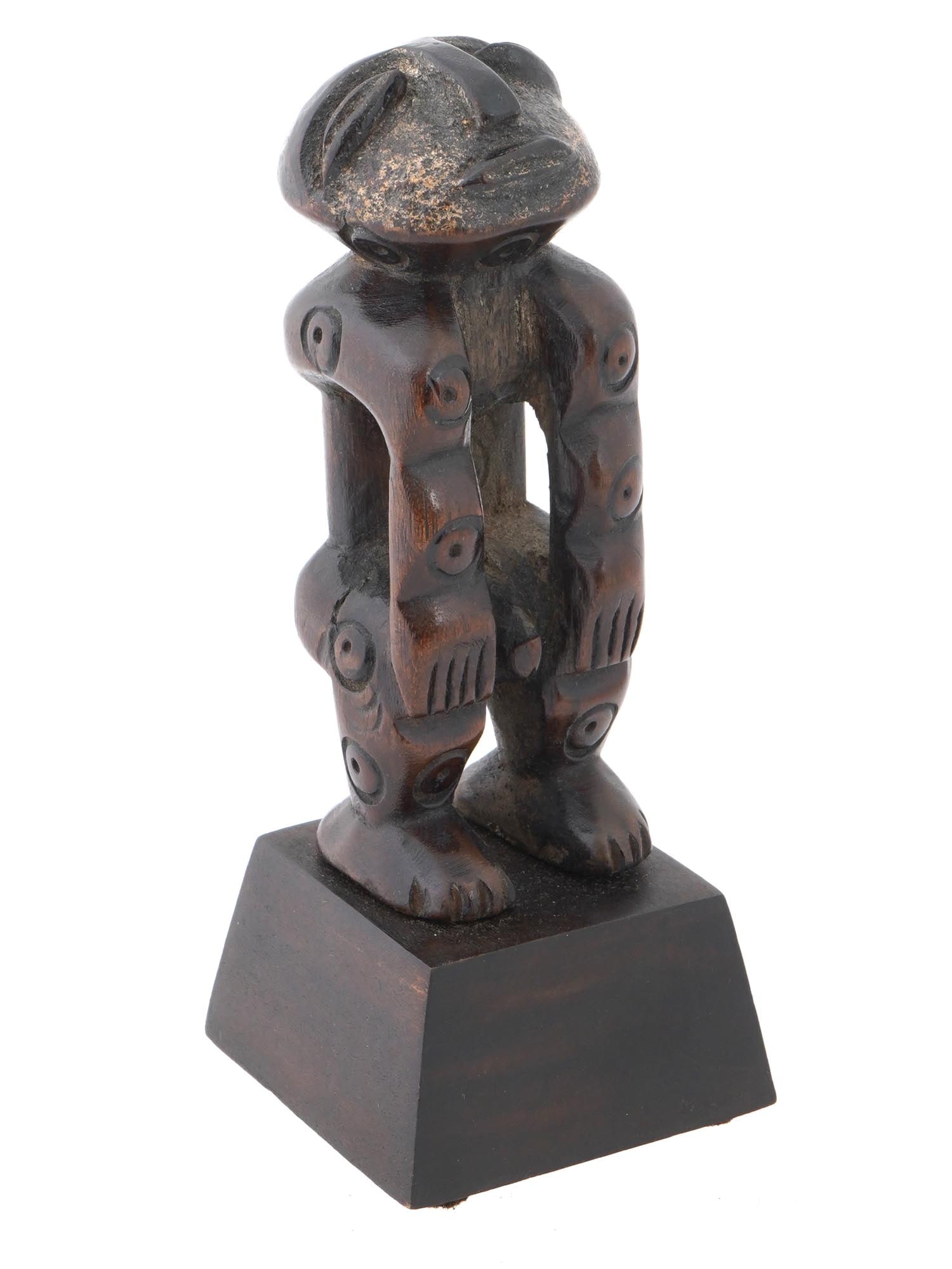 CENTRAL AFRICA CONGO MBOLE FETISH WOODEN FIGURINE: A small Central Africa Congo wooden fetish figurine of Mbole people. The miniature figurine represents a hand carved human body in a difficult pose with face up. The whole body is decorated with carve